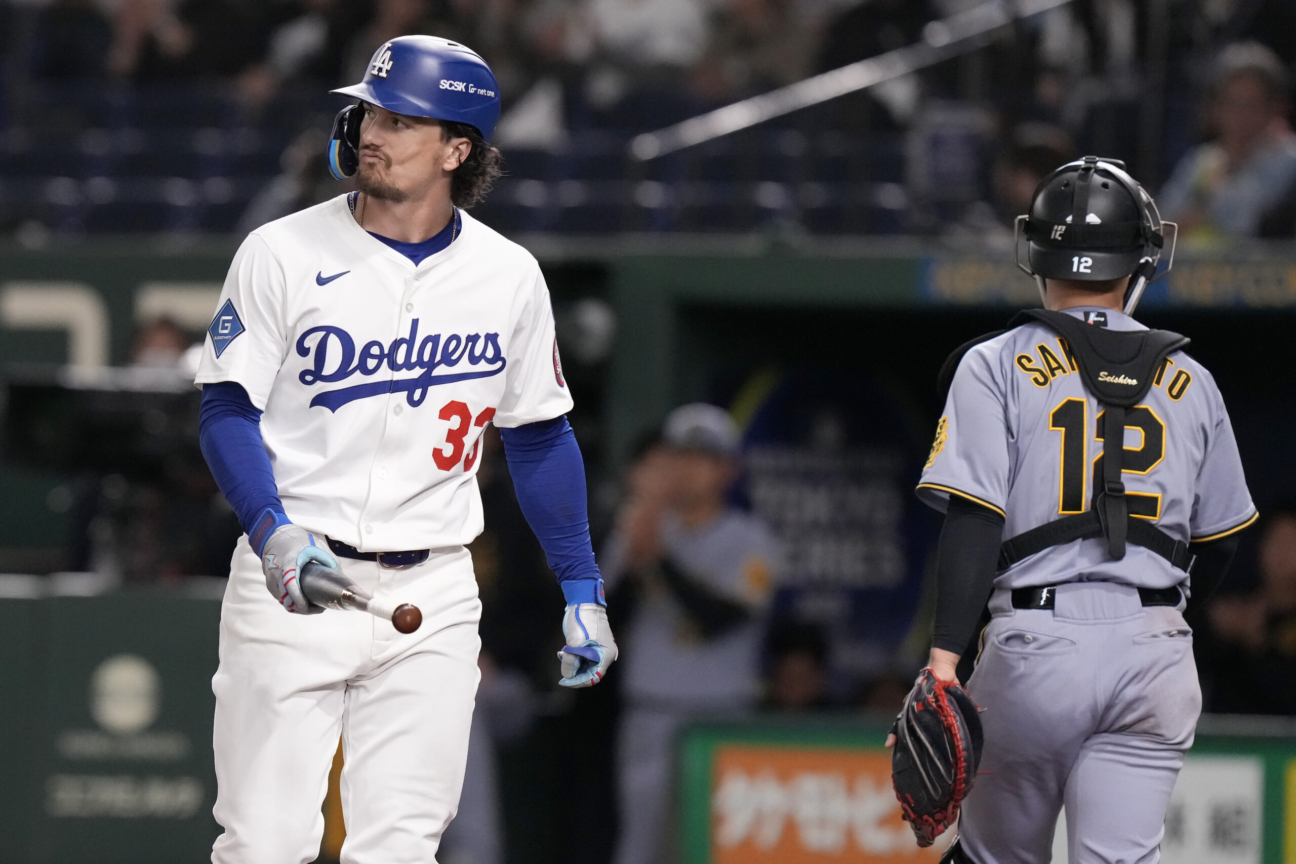 The Dodgers’ James Outman, left, reacts after striking out next...