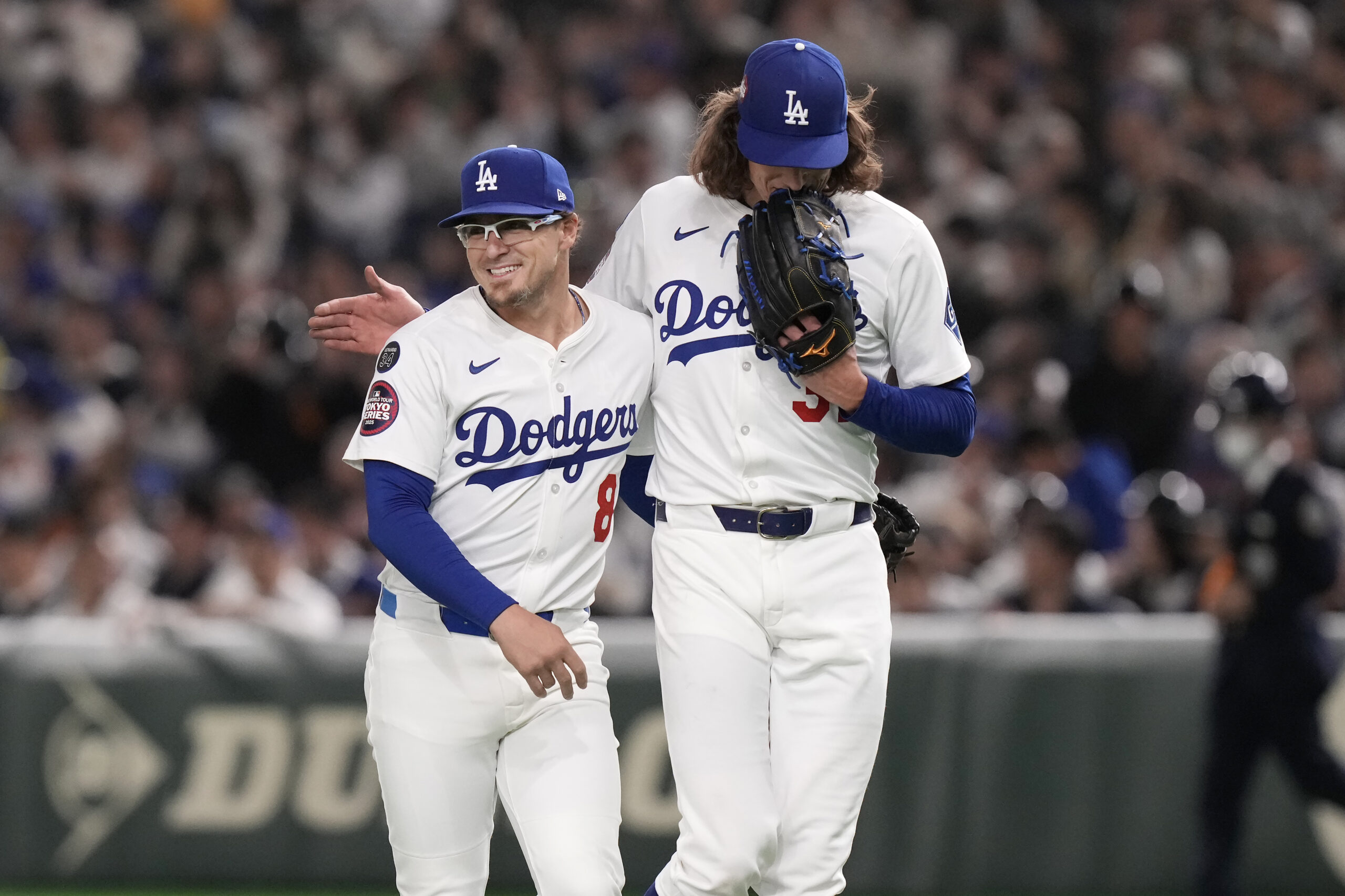 Dodgers infielder Kike Hernández, left, reacts with pitcher Tyler Glasnow...