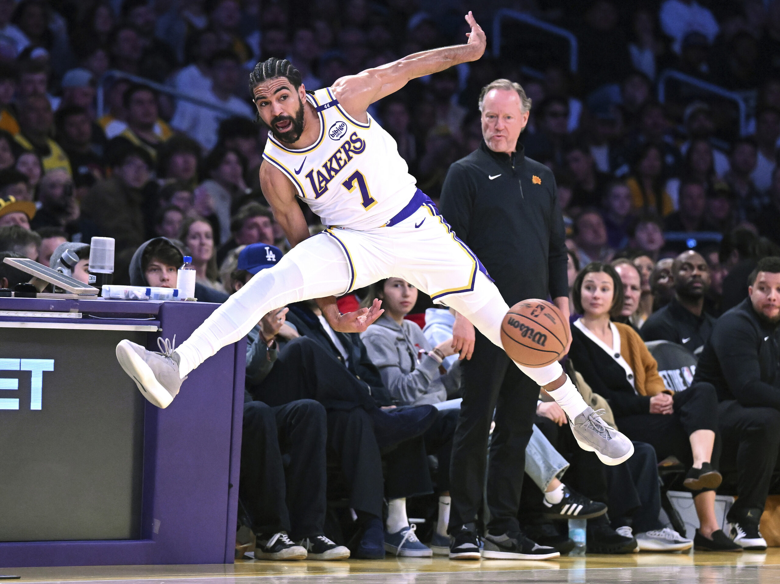 Lakers guard Gabe Vincent (7) saves the ball from going...