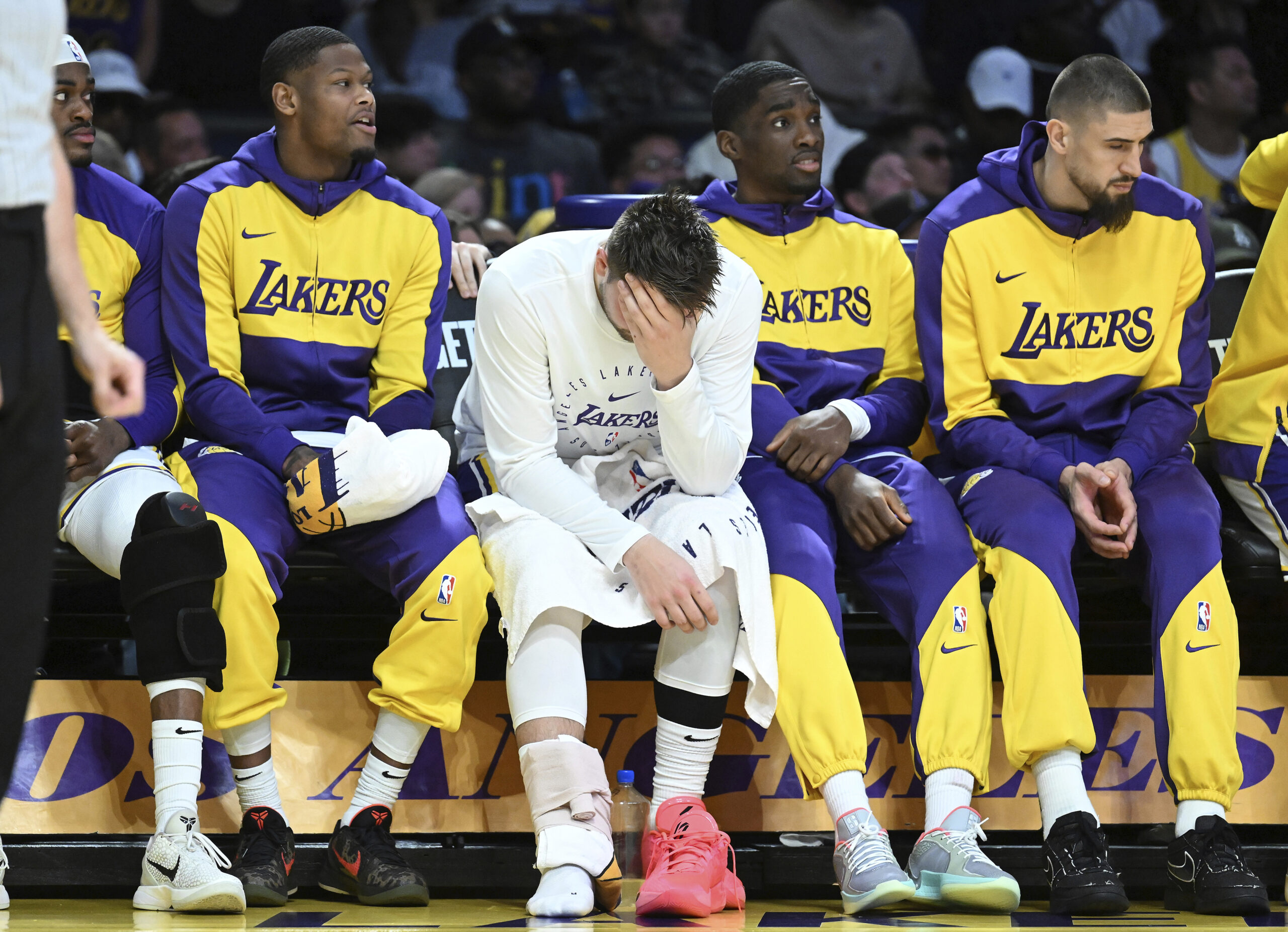 Lakers guard Luka Doncic, third from right, sits on the...