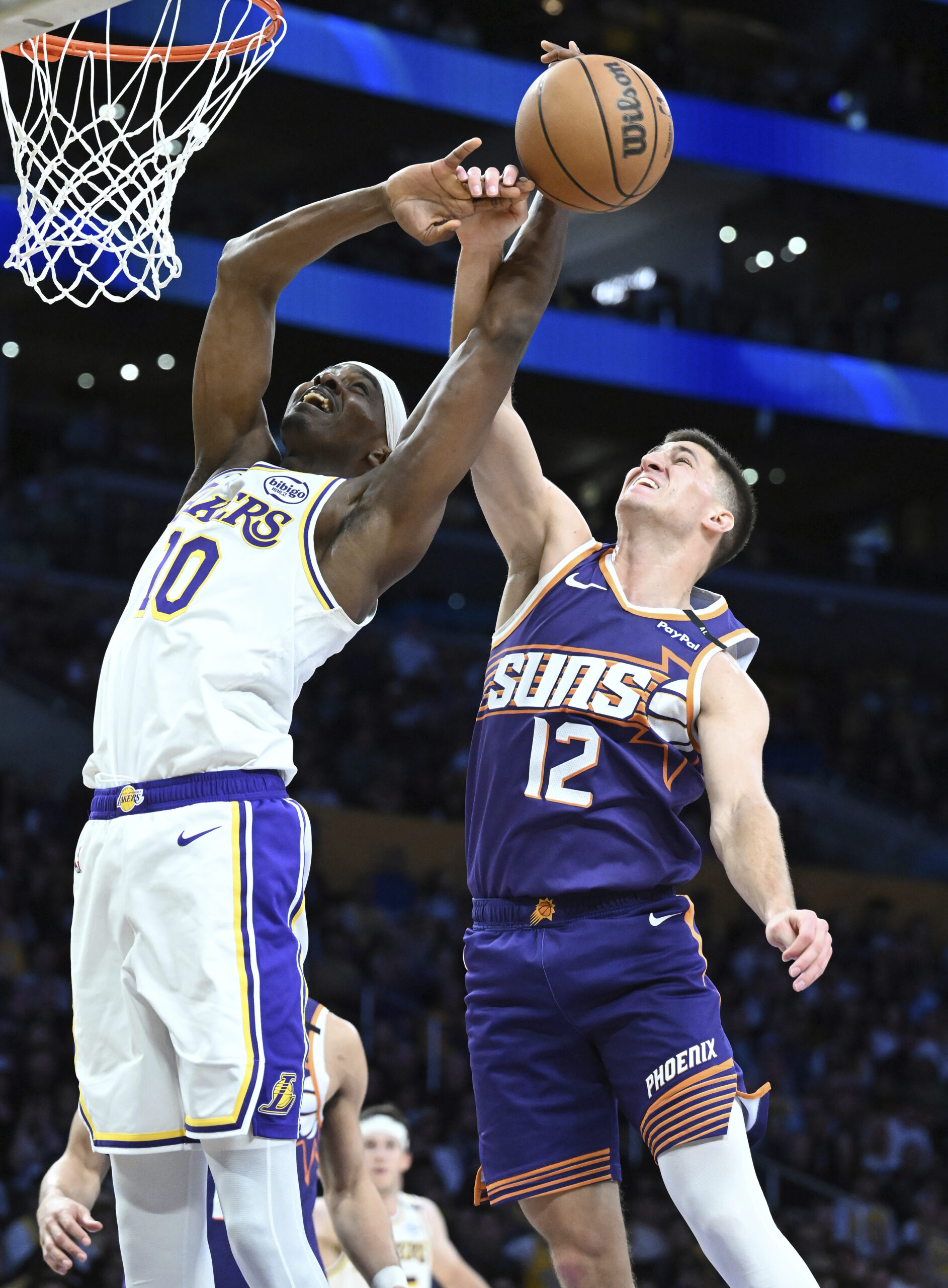 Lakers center Christian Koloko (10) has his shot blocked by...