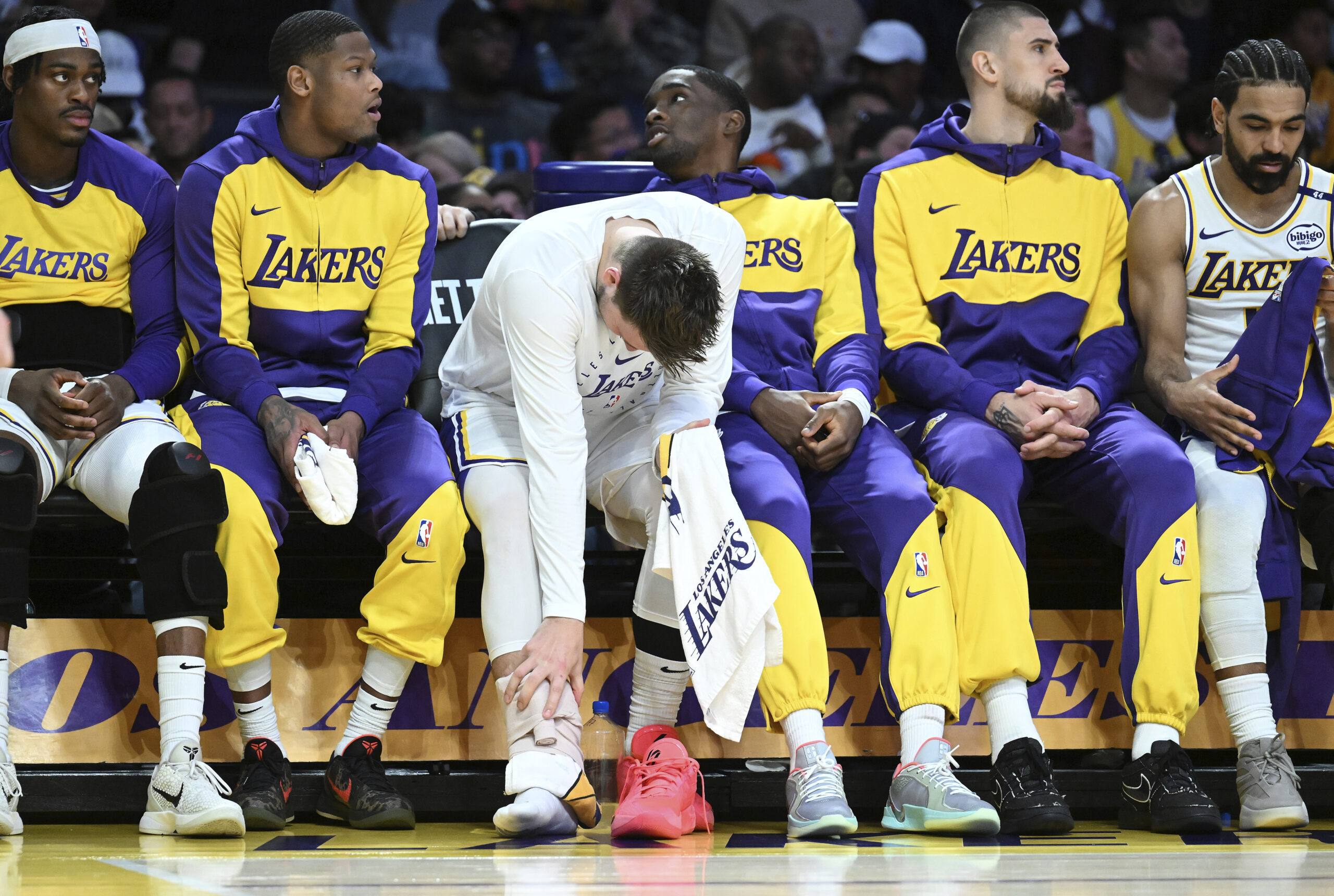 Lakers guard Luka Doncic, third from left, sits on the...