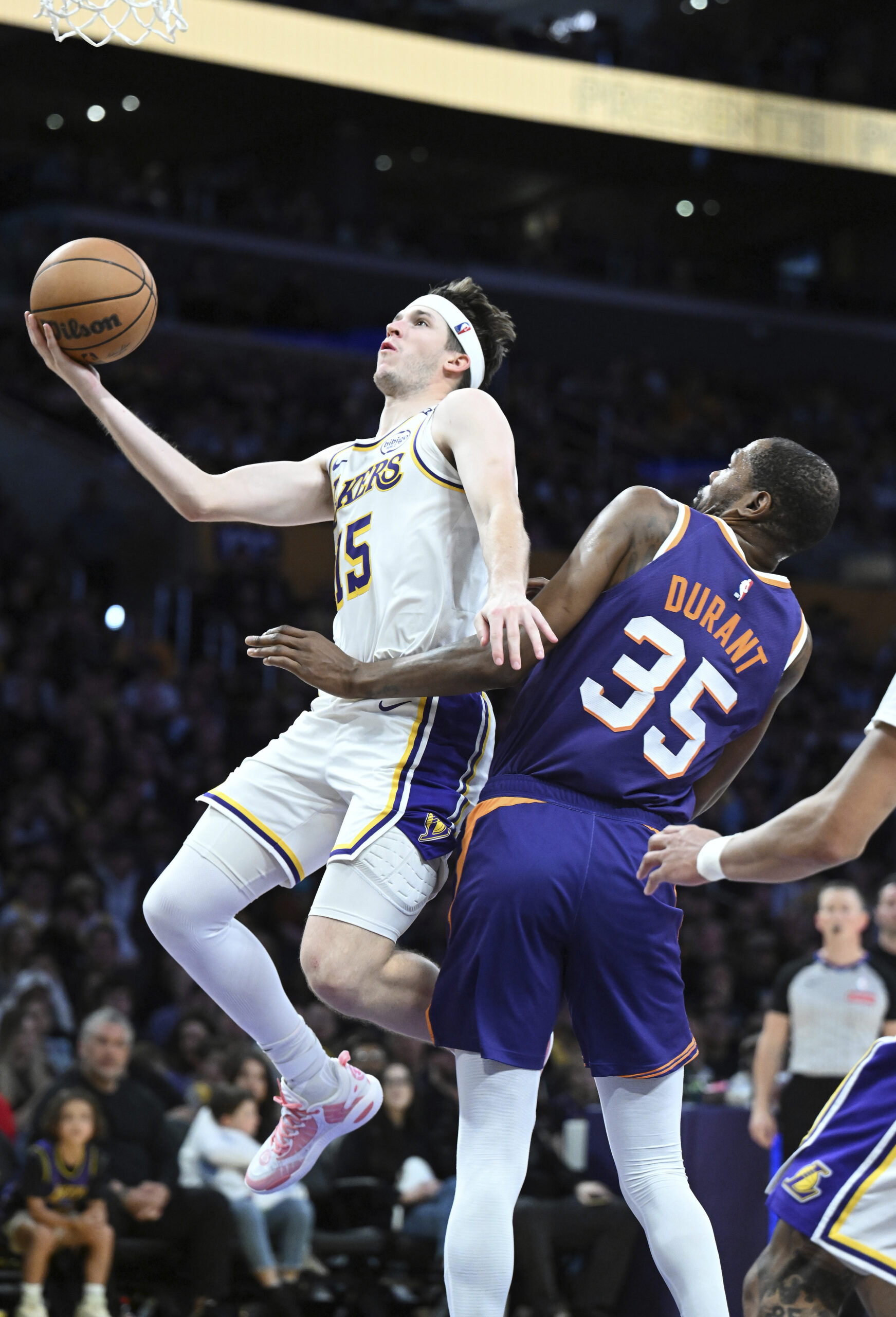 Lakers guard Austin Reaves (15) drives past Phoenix Suns forward...