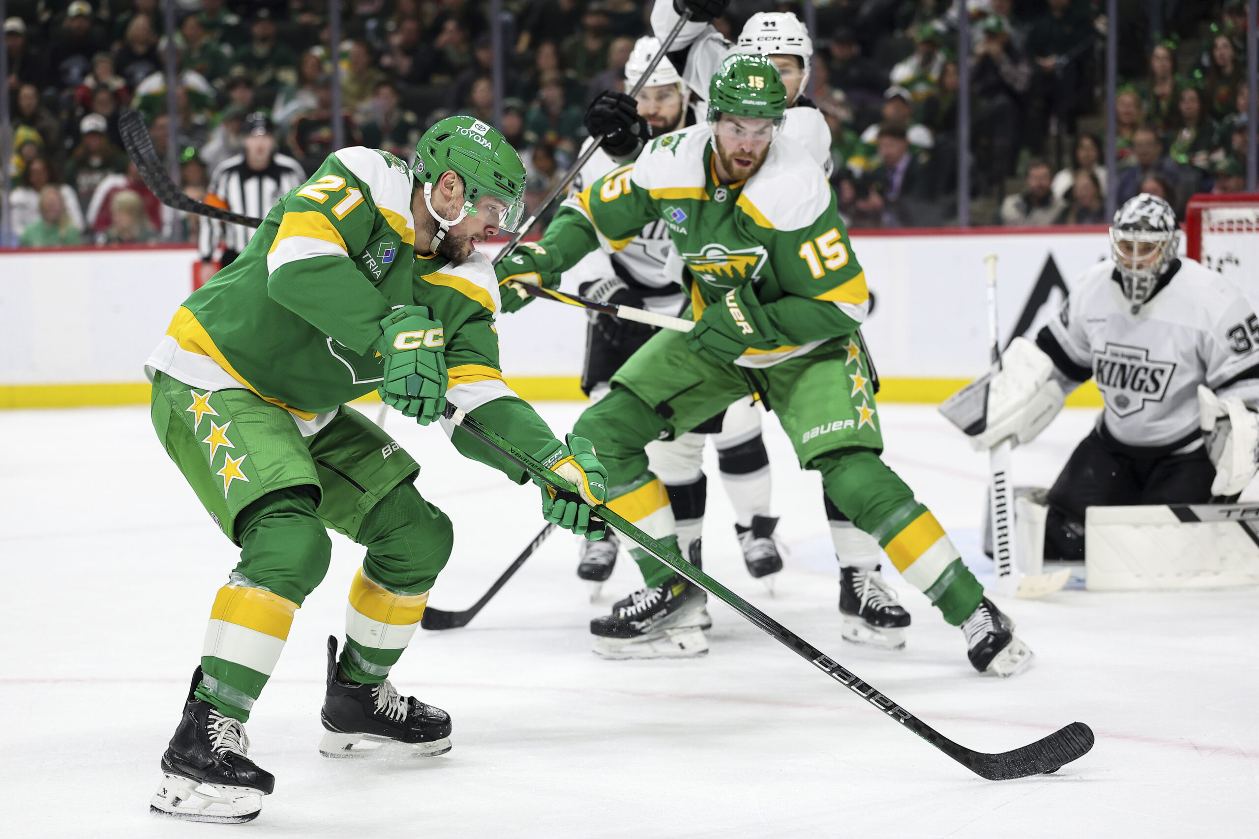 Minnesota Wild center Brendan Gaunce, left, skates with the puck...