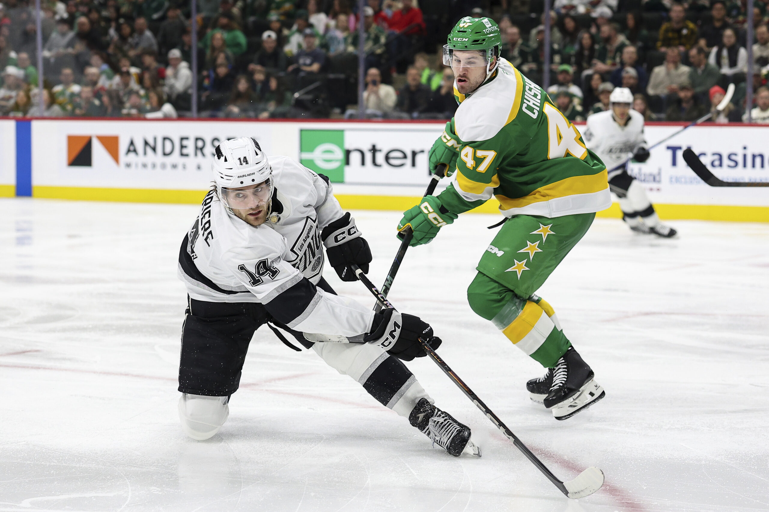 Kings right wing Alex Laferriere, left, and Minnesota Wild defenseman...