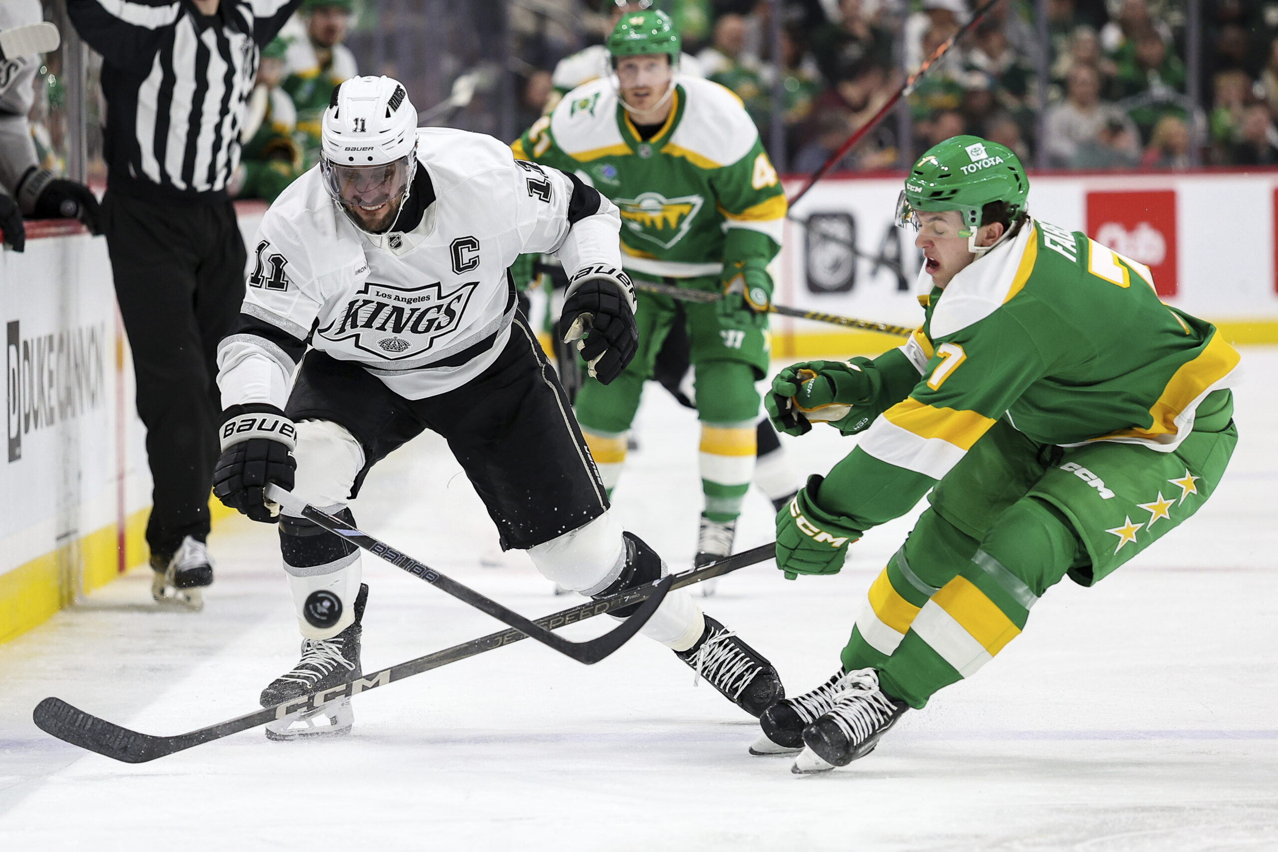 Kings center Anze Kopitar, left, and Minnesota Wild defenseman Brock...