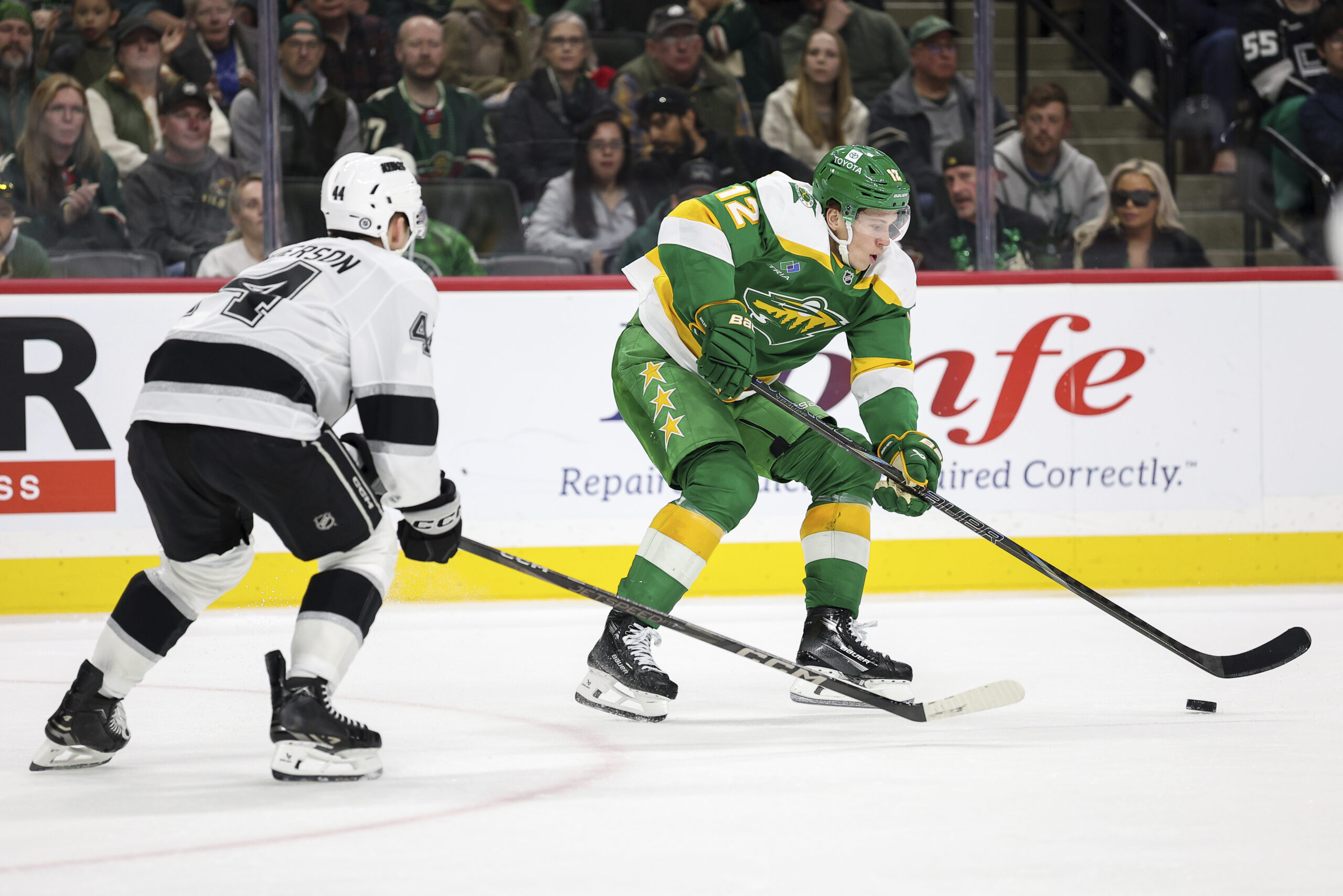 Minnesota Wild left wing Matt Boldy, right, skates with the...