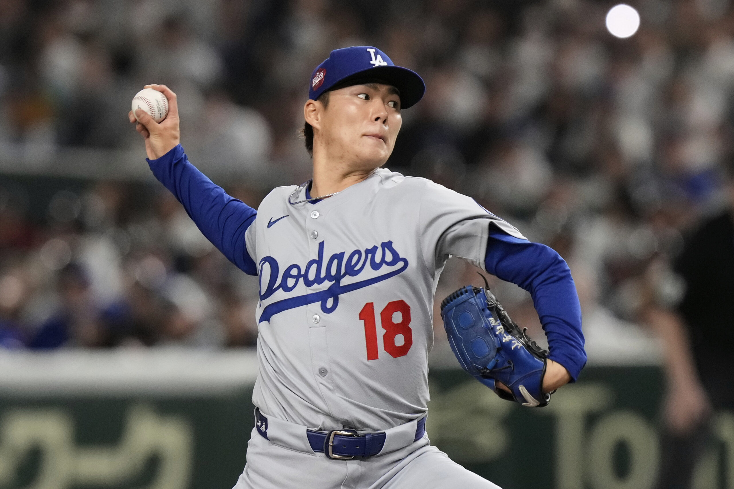 Los Angeles Dodgers starting pitcher Yoshinobu Yamamoto throws to the...