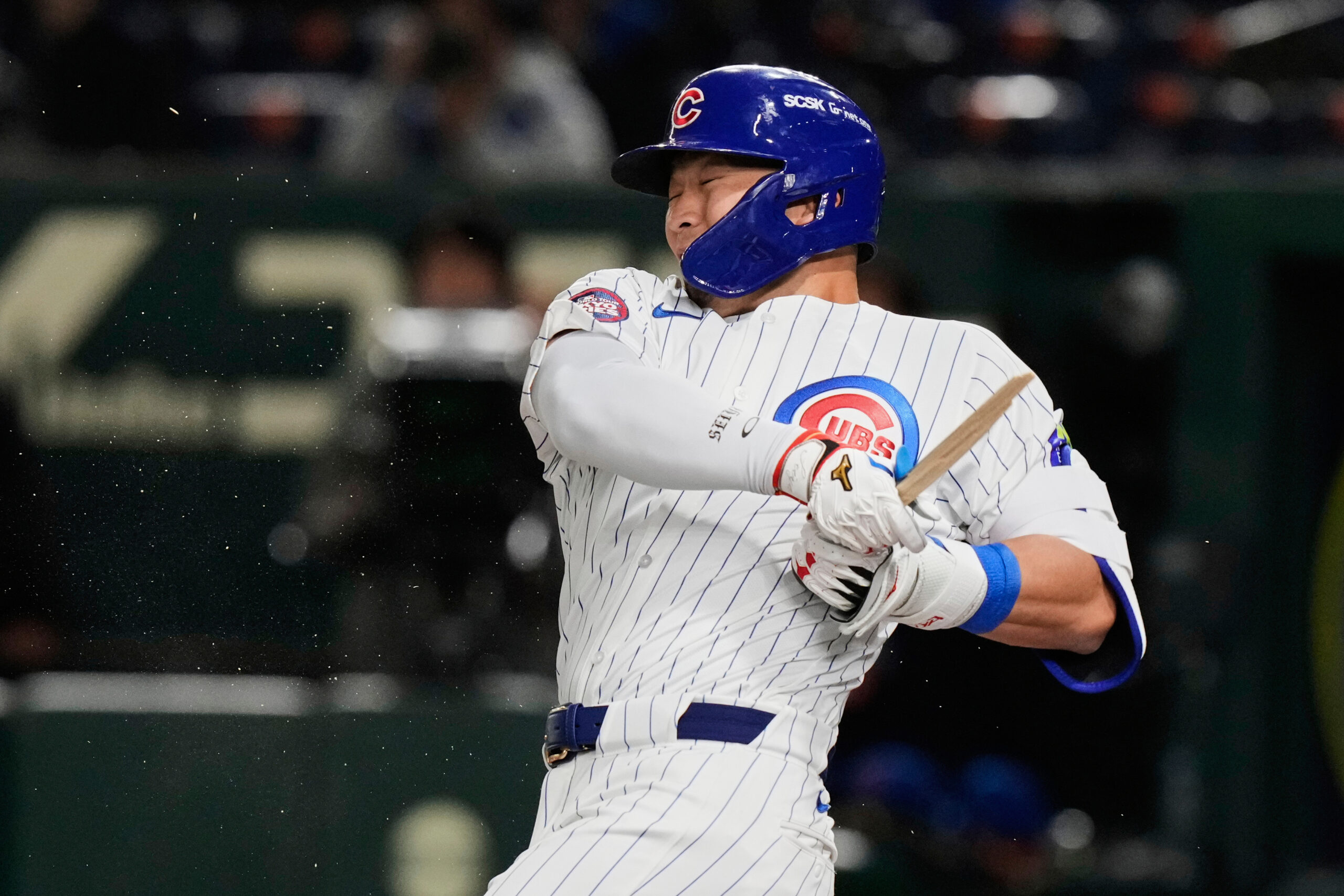 Chicago Cubs’ Seiya Suzuki holds on to his broken bat...