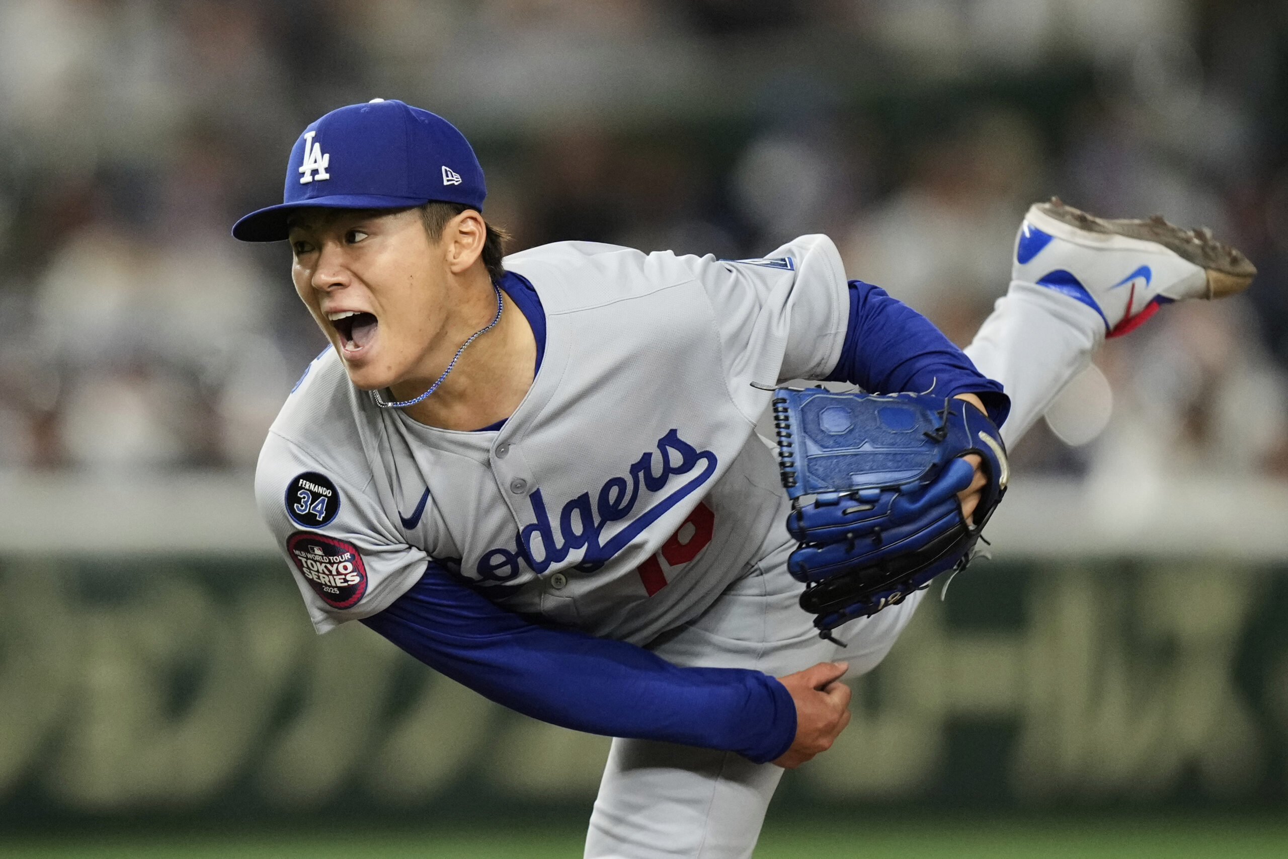 Los Angeles Dodgers starting pitcher Yoshinobu Yamamoto throws to the...