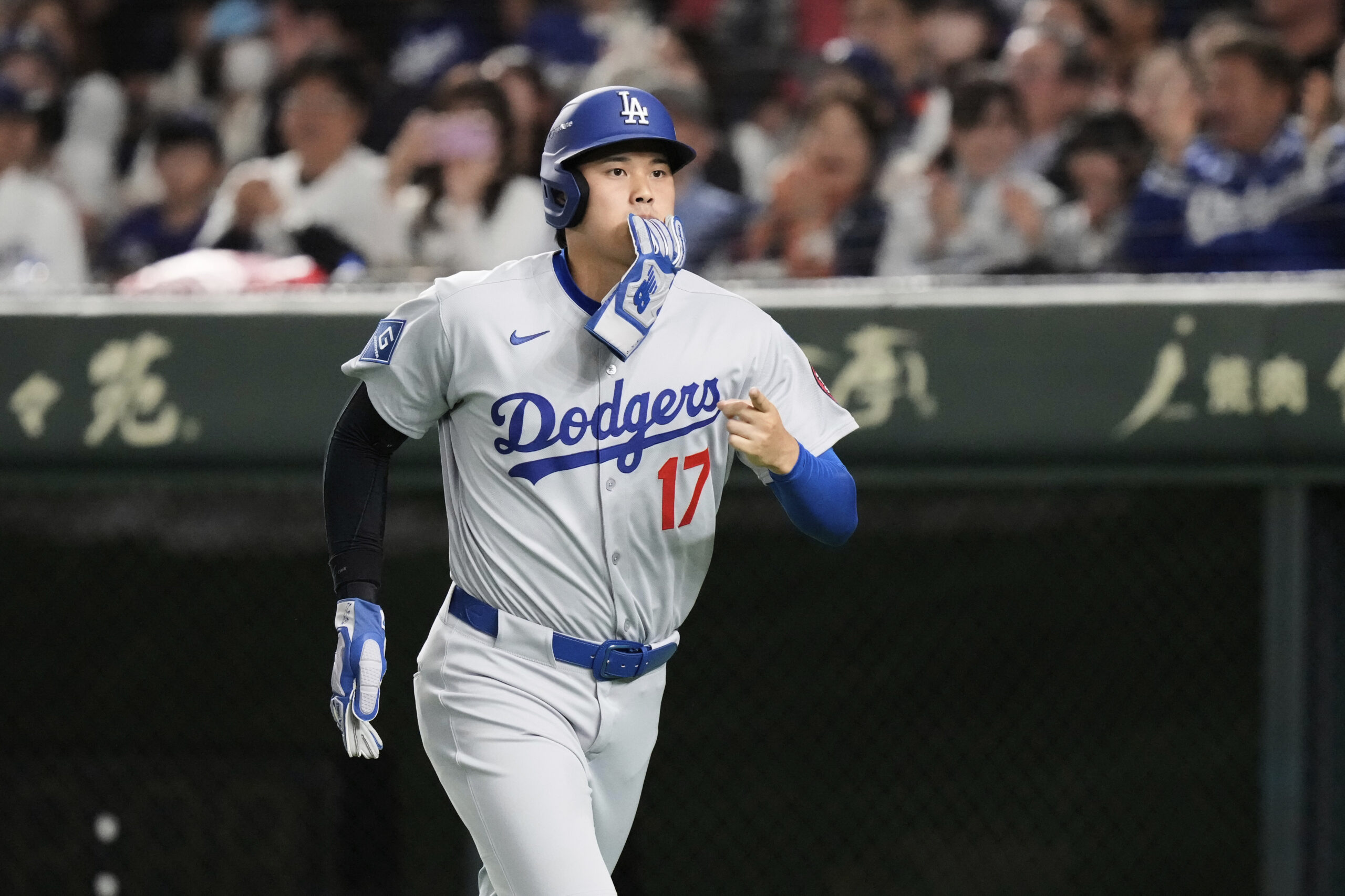 Los Angeles Dodgers’ Shohei Ohtani jogs to the dugout after...