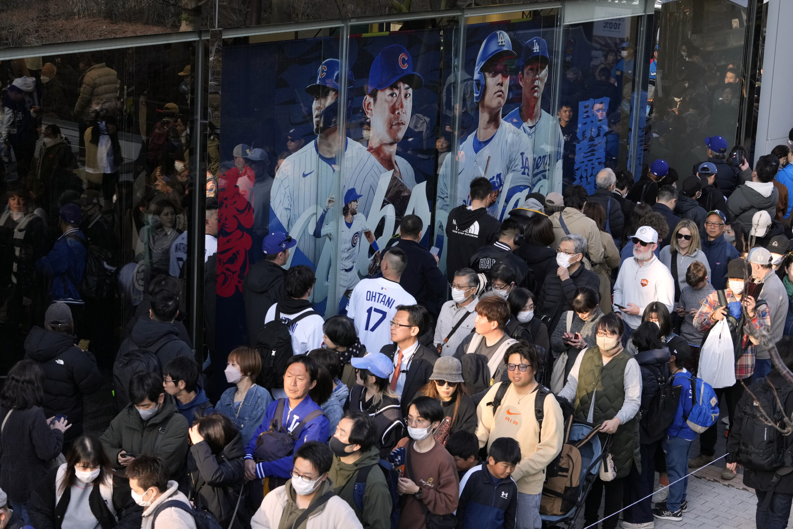 People wait in queue to enter an official shop before...