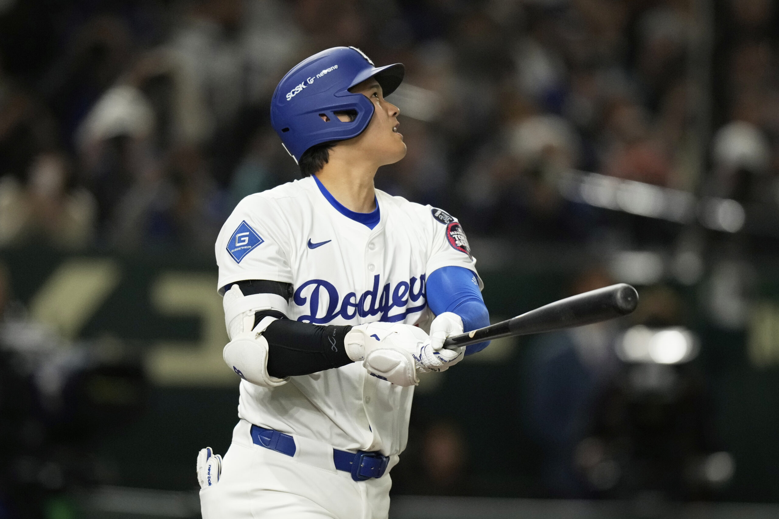 The Dodgers’ Shohei Ohtani follows through on a solo home...