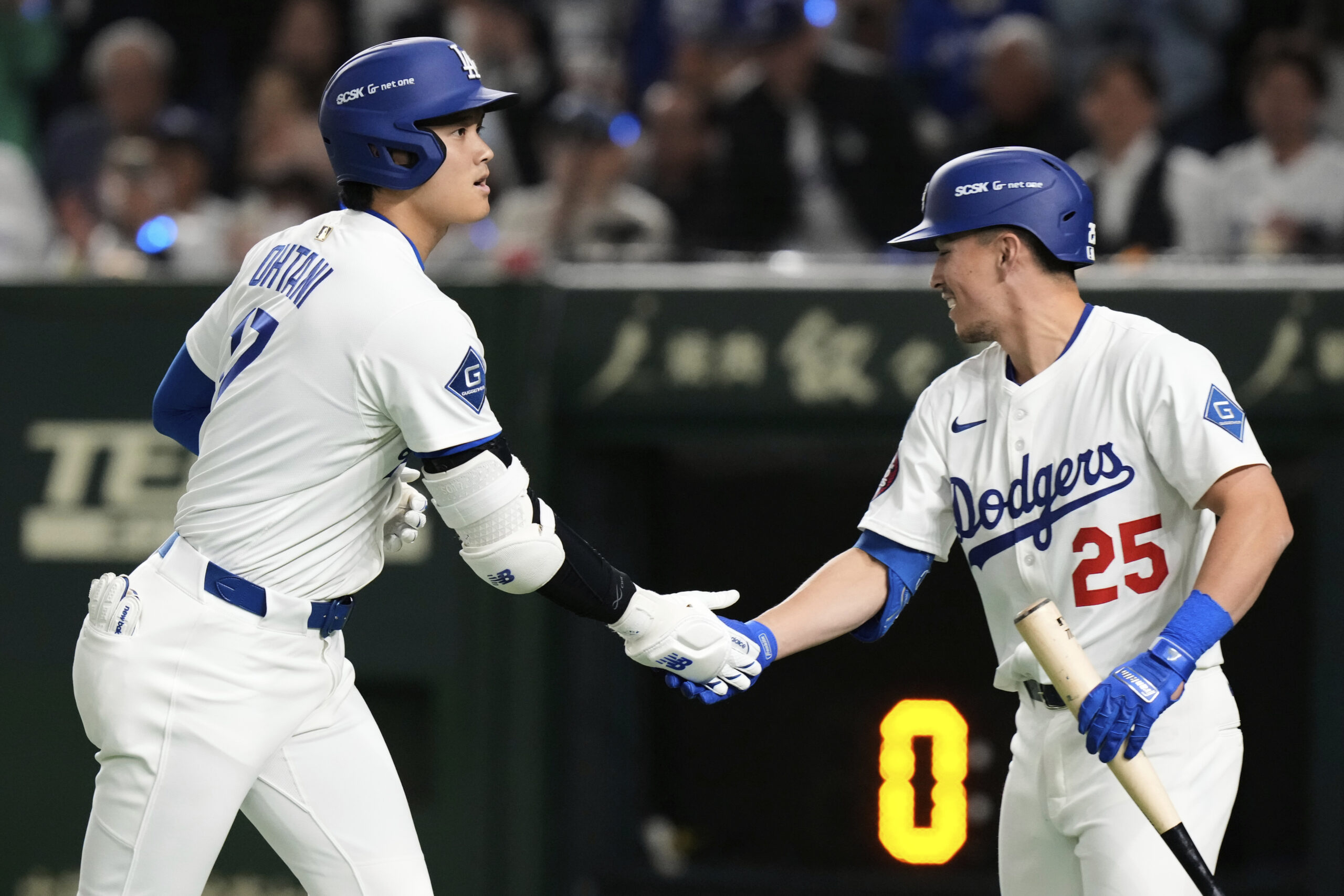 The Dodgers’ Shohei Ohtani, left, celebrates his solo home run...