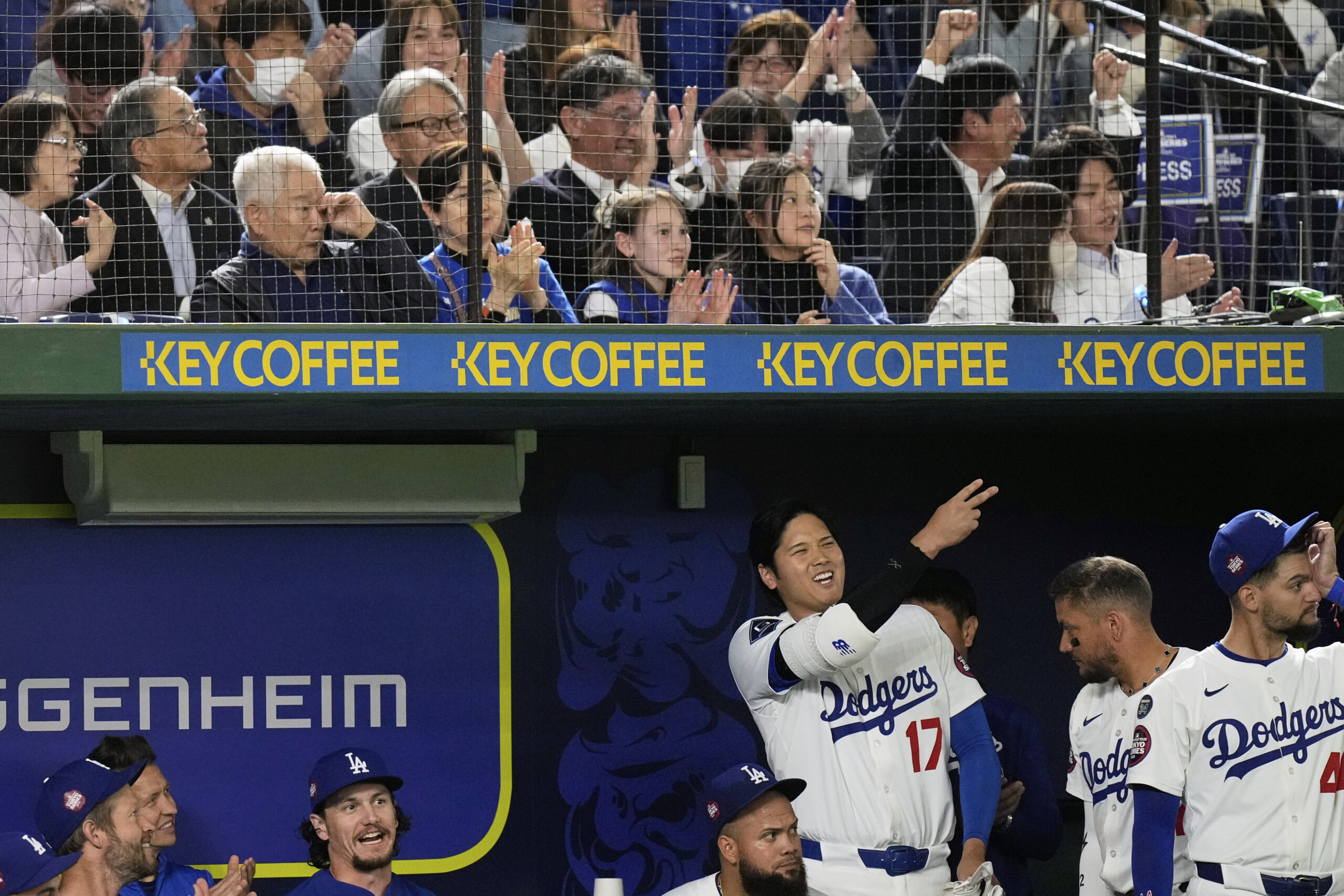 The Dodgers’ Shohei Ohtani (17) celebrates in the dugout after...