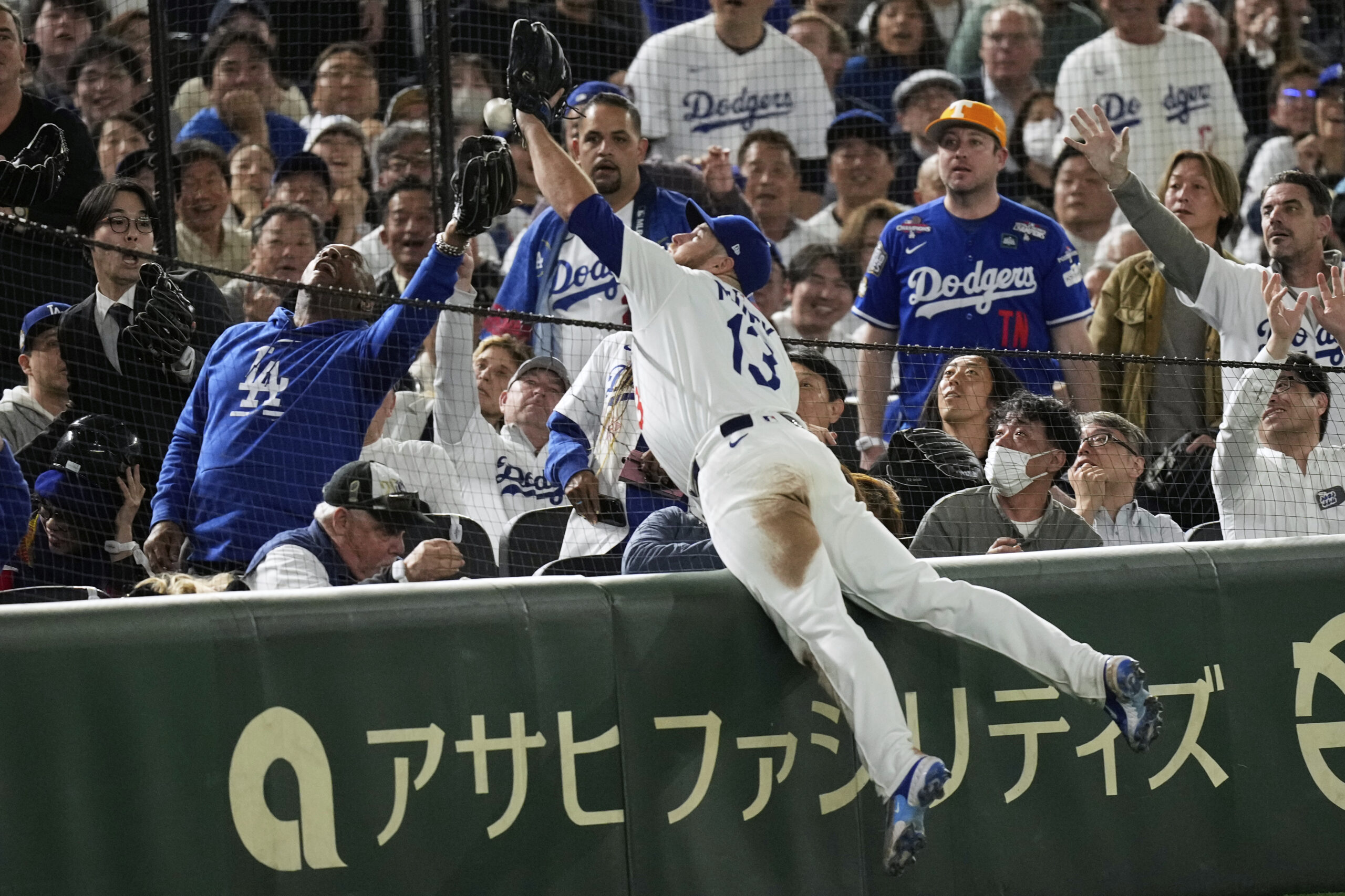 Dodgers third baseman Max Muncy makes a diving attempt on...