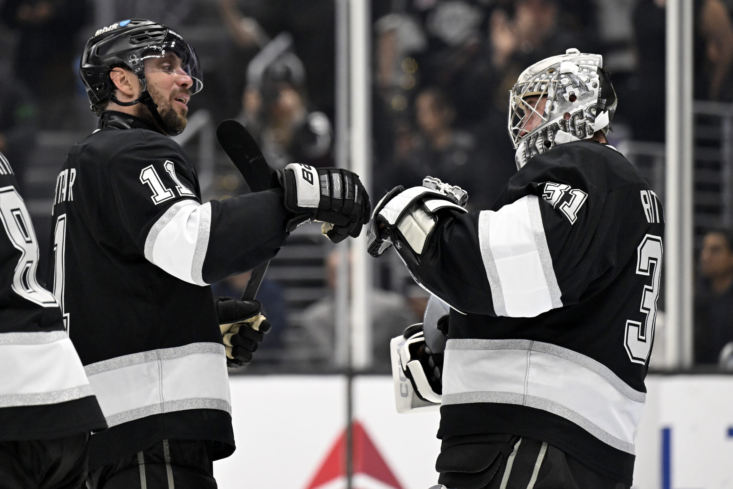 Kings center Anze Kopitar (11) celebrates with goaltender David Rittich...