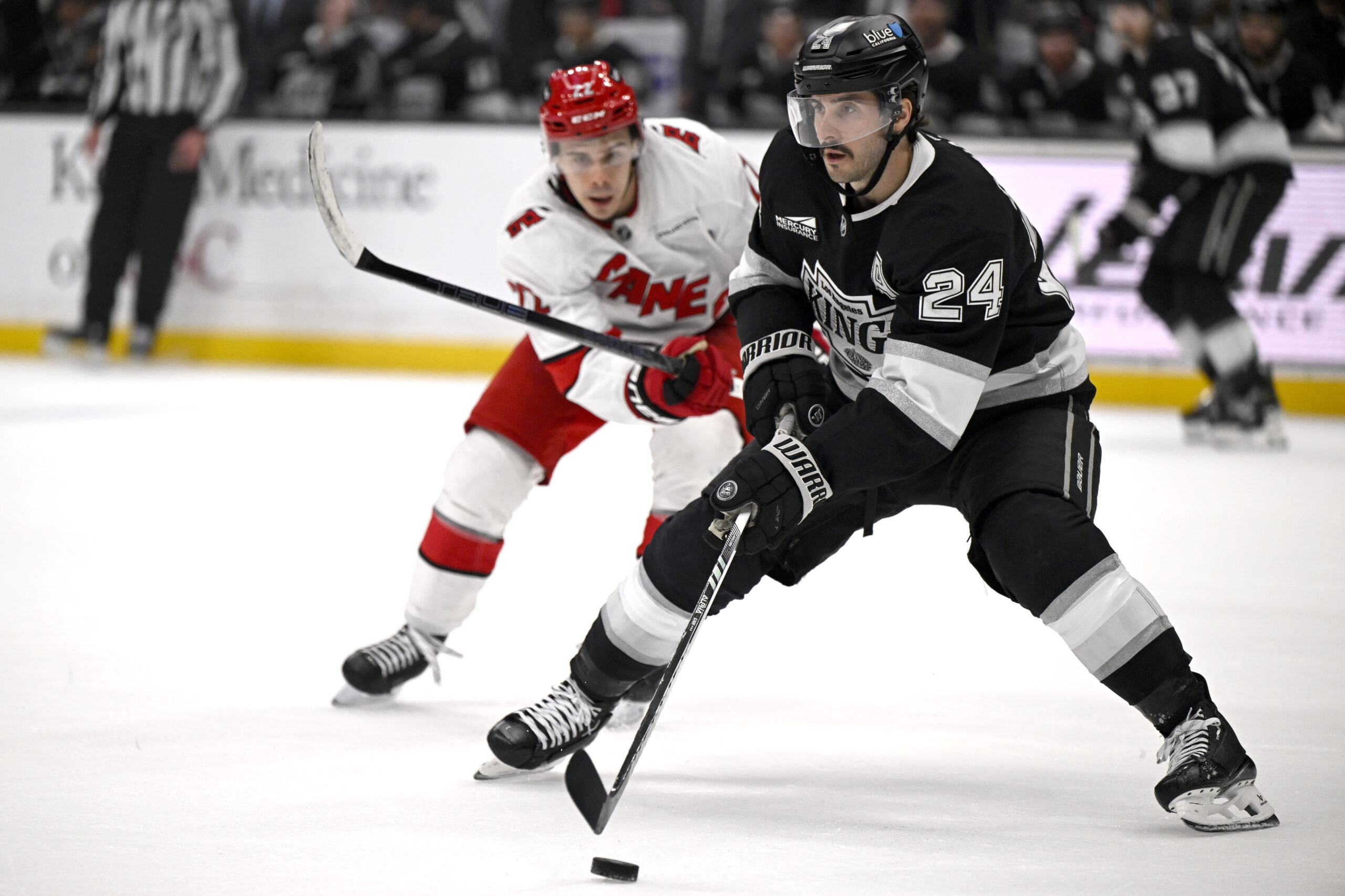 Kings center Phillip Danault (24) controls the puck with pressure...