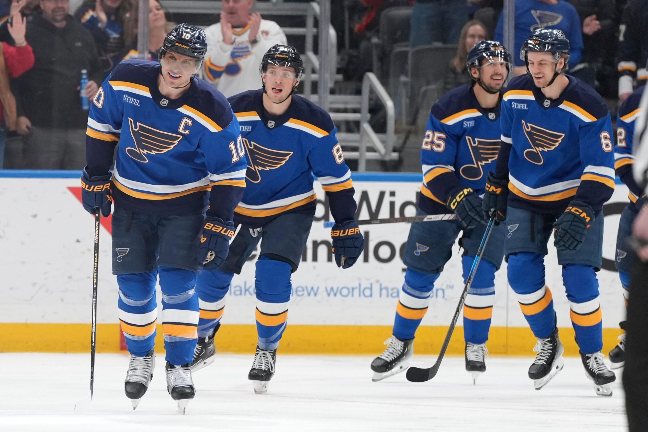 St. Louis Blues’ Brayden Schenn, left, celebrates with teammates after...