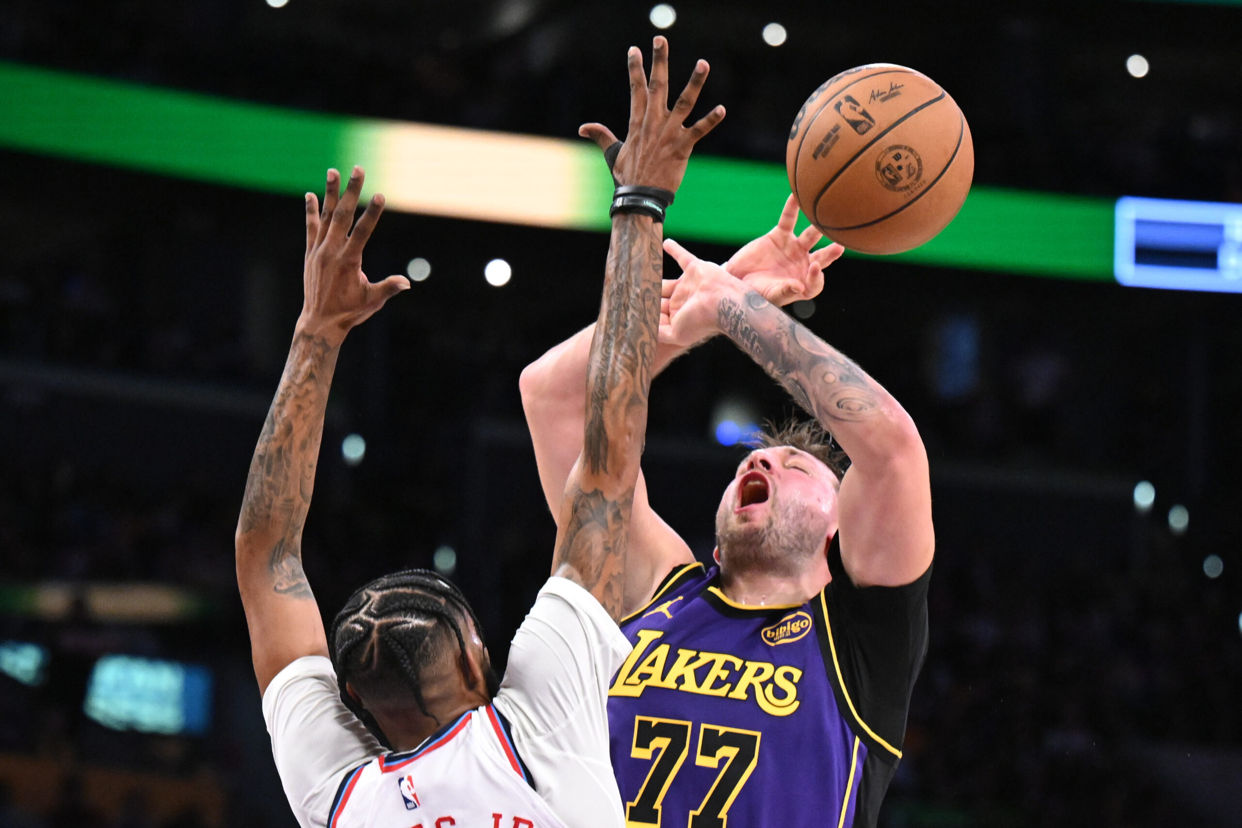 Lakers star Luka Doncic, right, is fouled by Clippers forward...