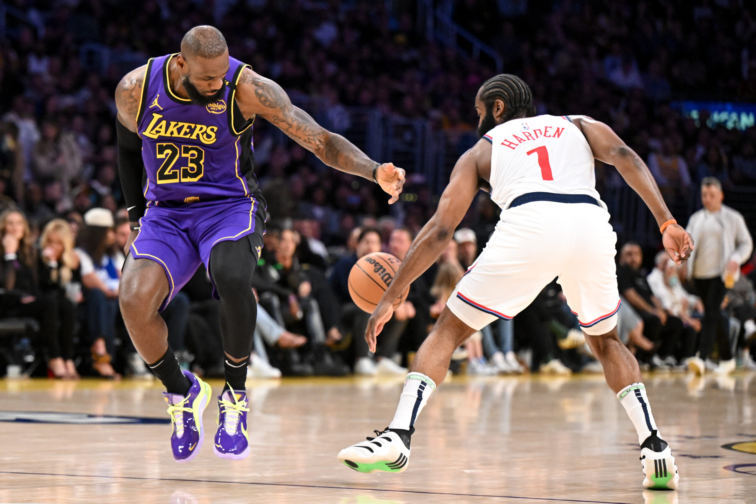 Clippers star James Harden, right, knocks the ball away from...