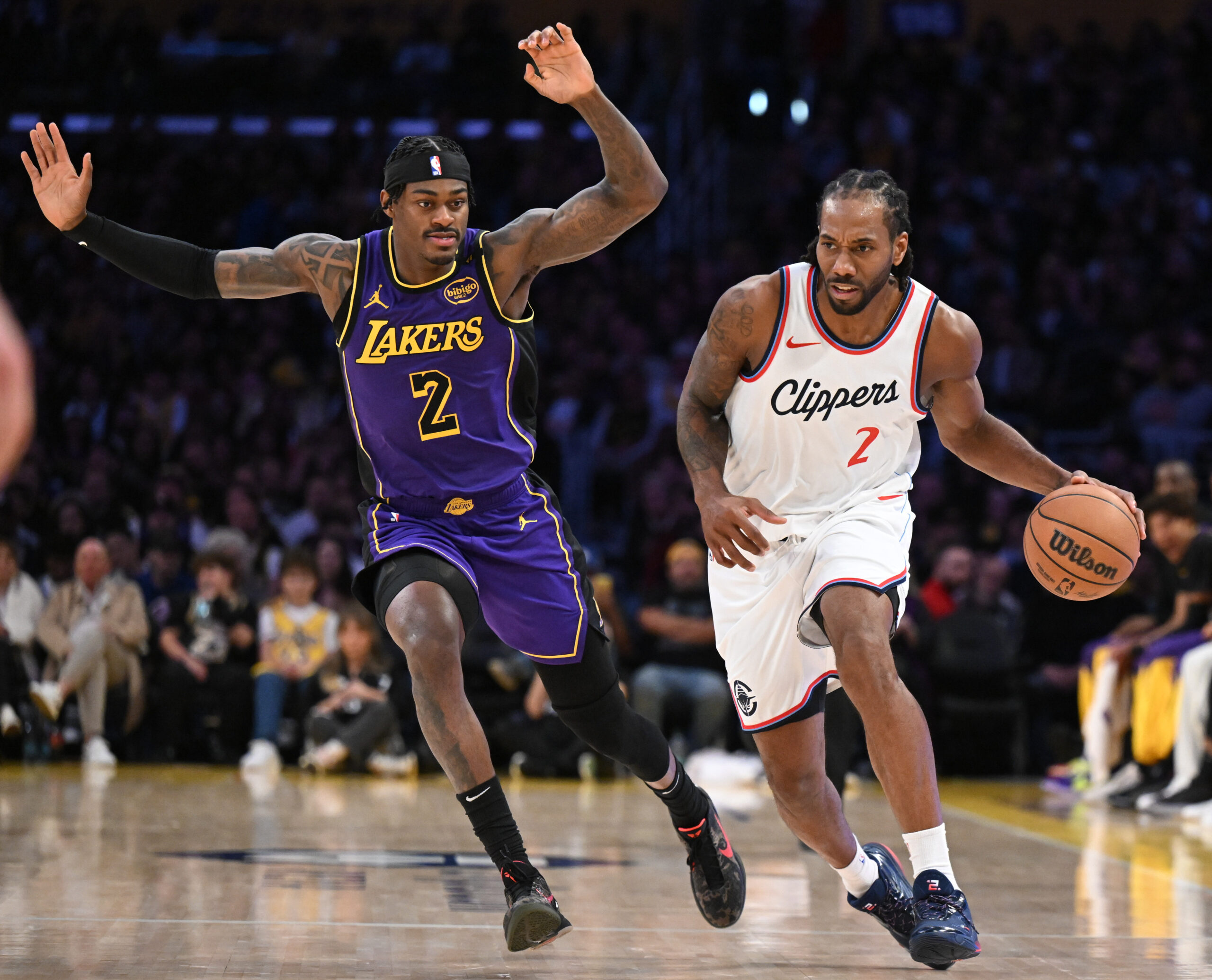 Clippers star Kawhi Leonard handles the ball as Lakers forward...