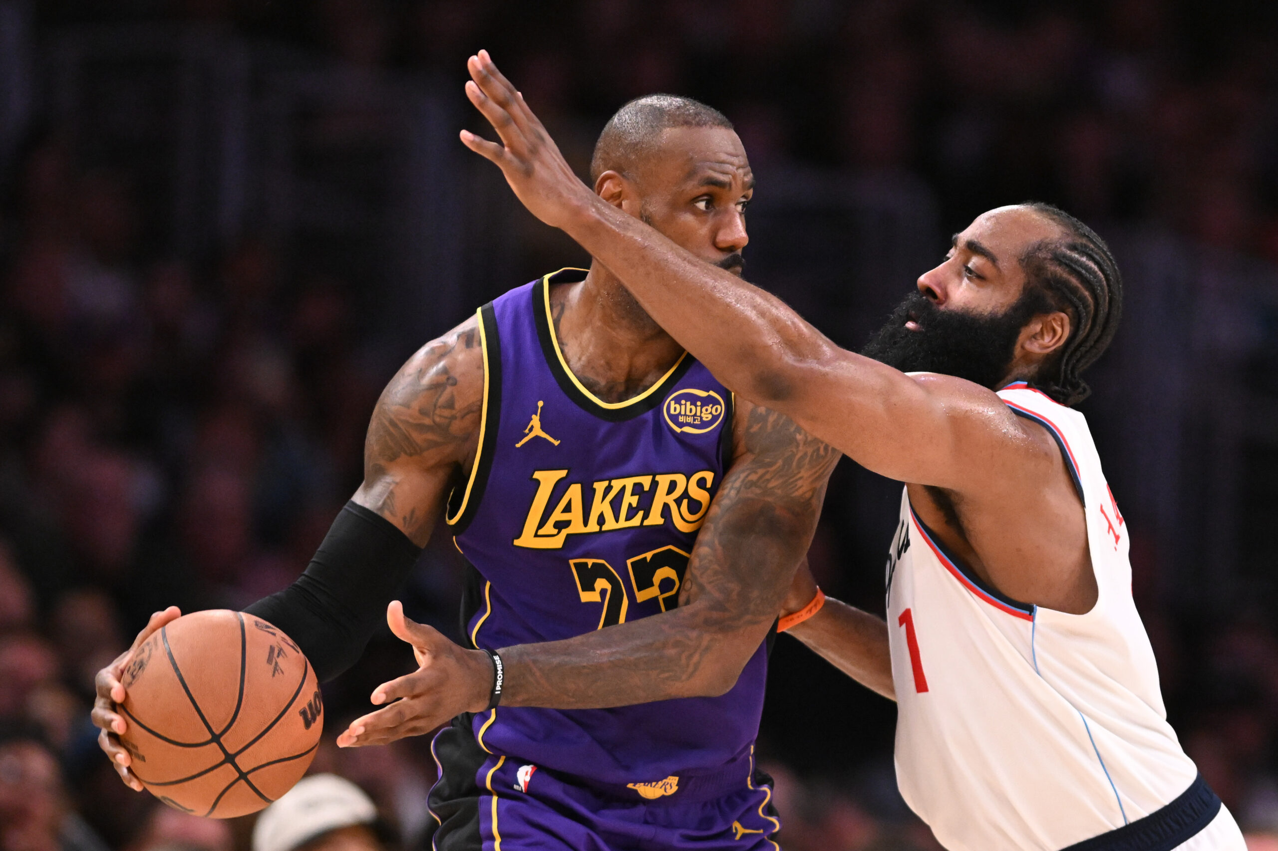 Lakers star LeBron James looks to pass as Clippers star...