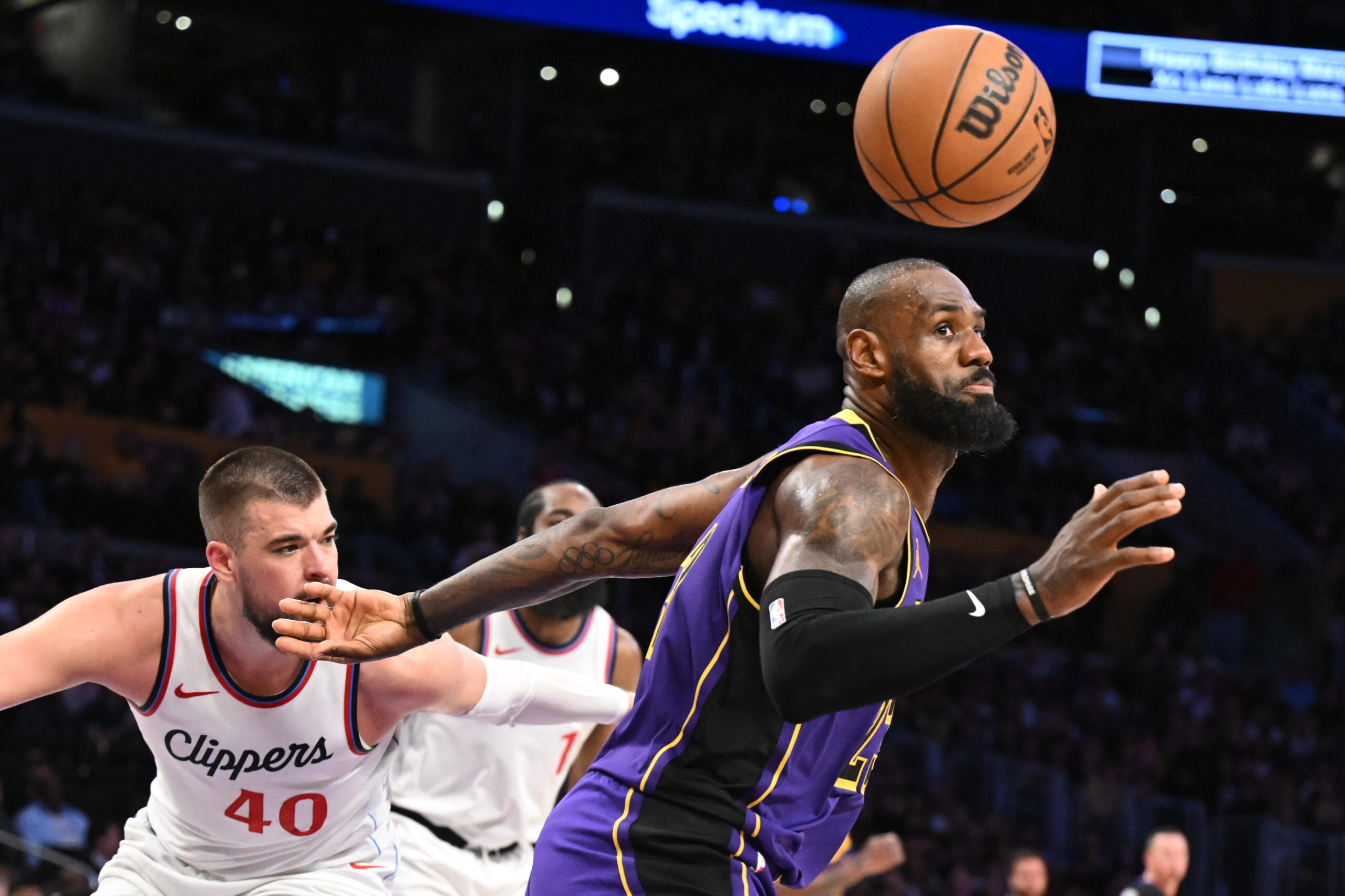 Clippers center Ivica Zubac, left, knocks the ball away from...