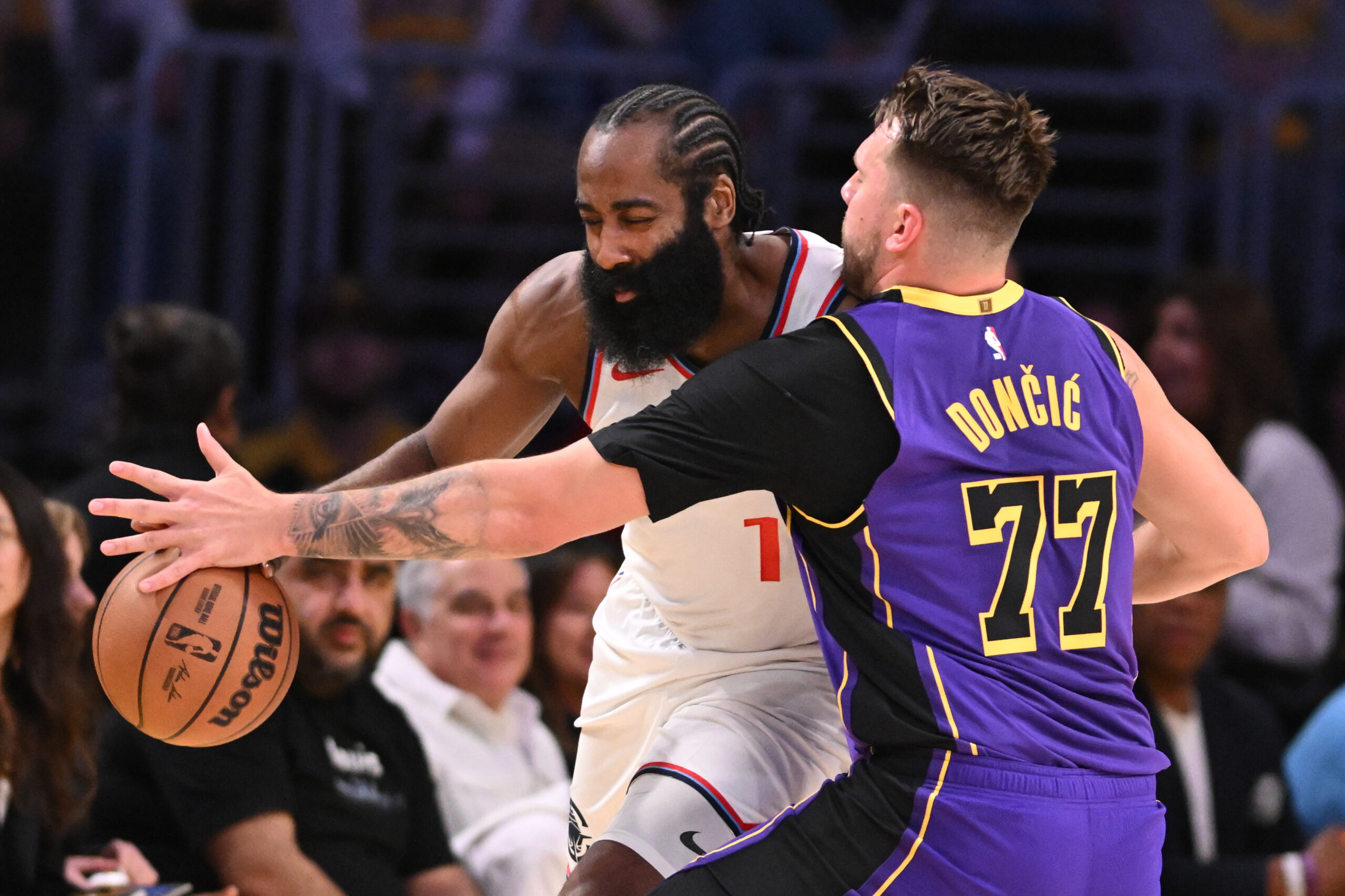 Lakers guard Luka Doncic, right, defends Clippers guard James Harden...