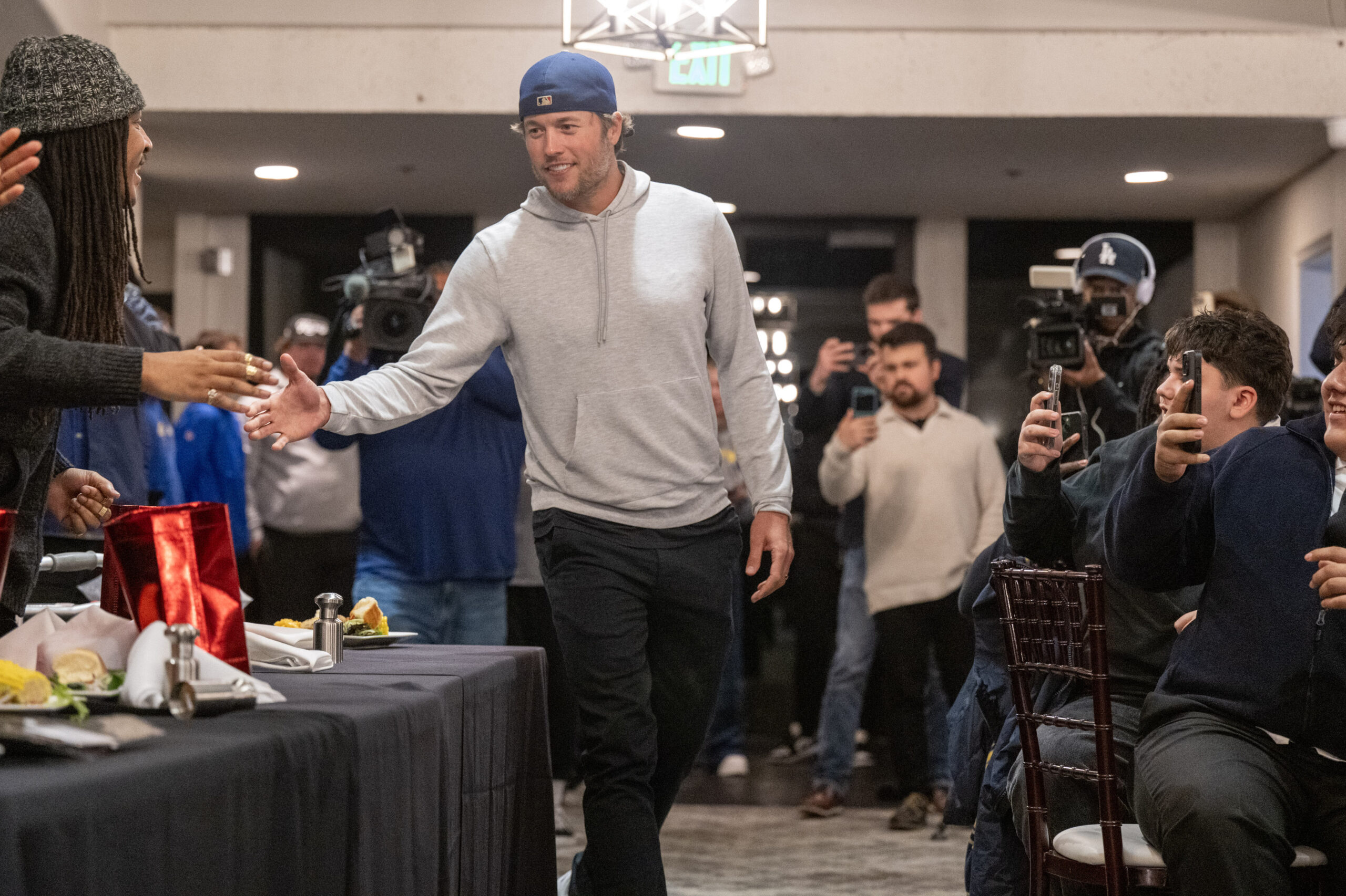 Rams quarterback Matthew Stafford shakes hands before announcing that he...