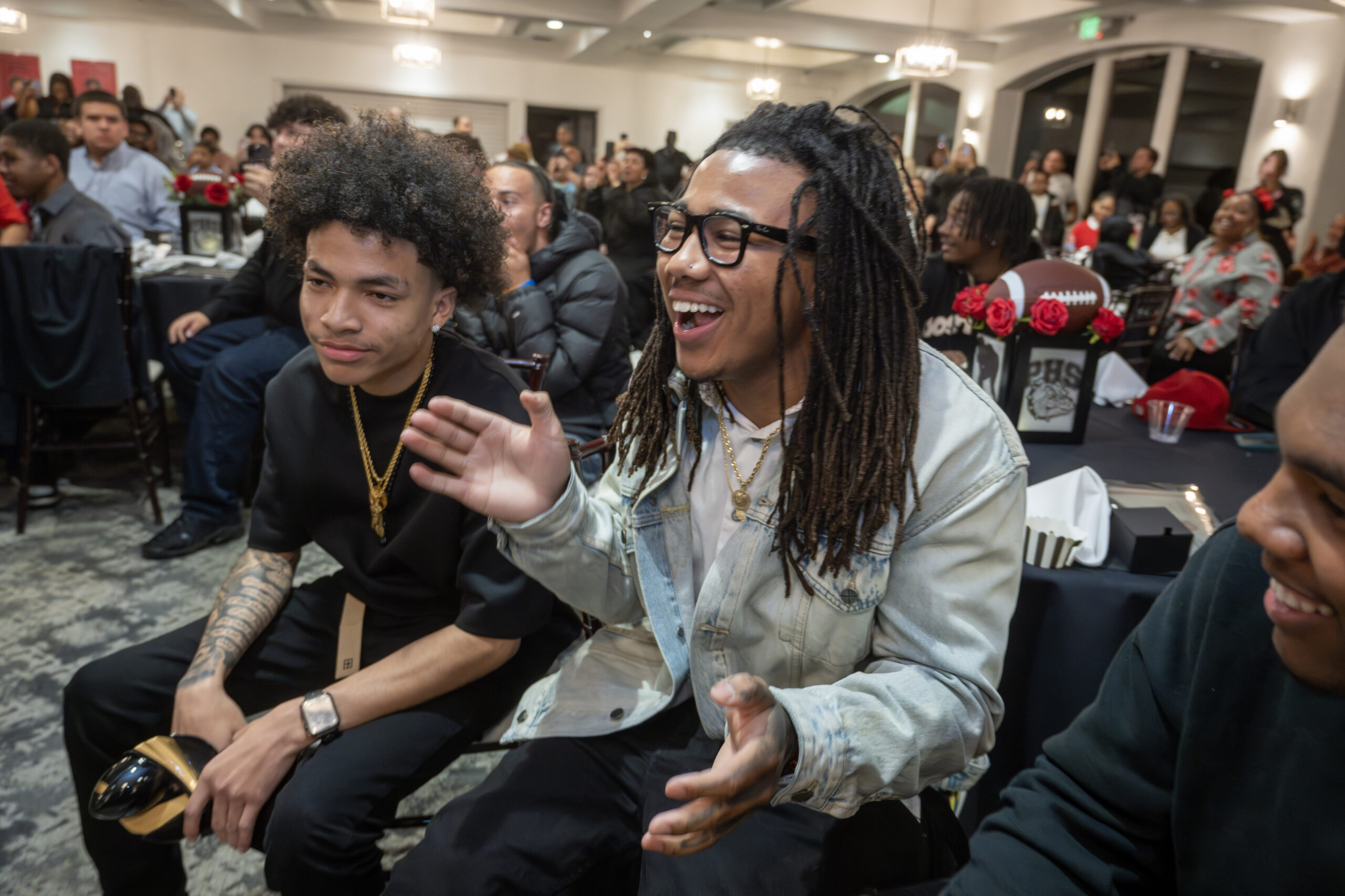 Pasadena High football players react after Rams quarterback, not pictured,...