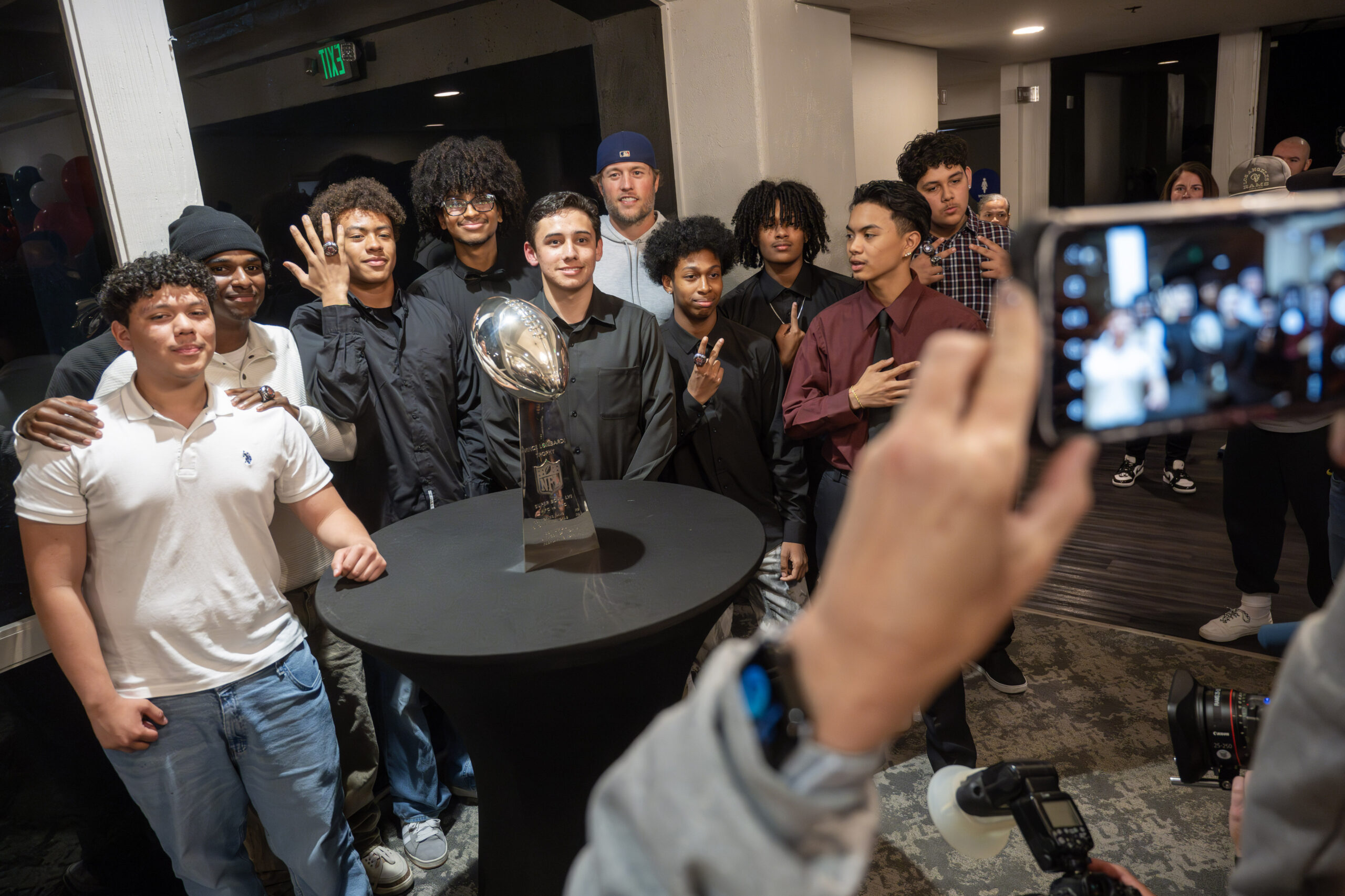 Rams quarterback Matthew Stafford, top center, poses for photos after...