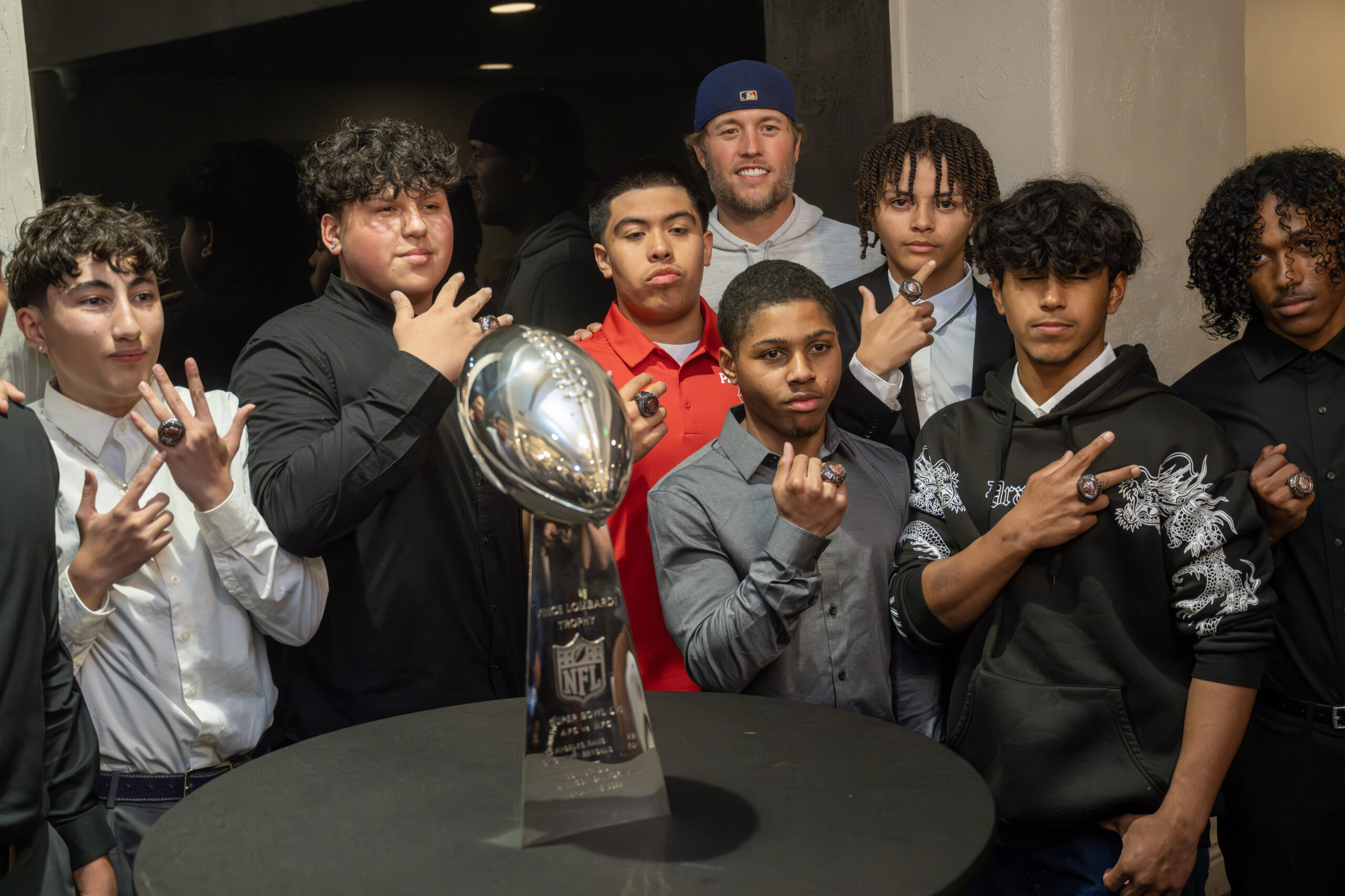 Rams quarterback Matthew Stafford, top center, poses for photos with...