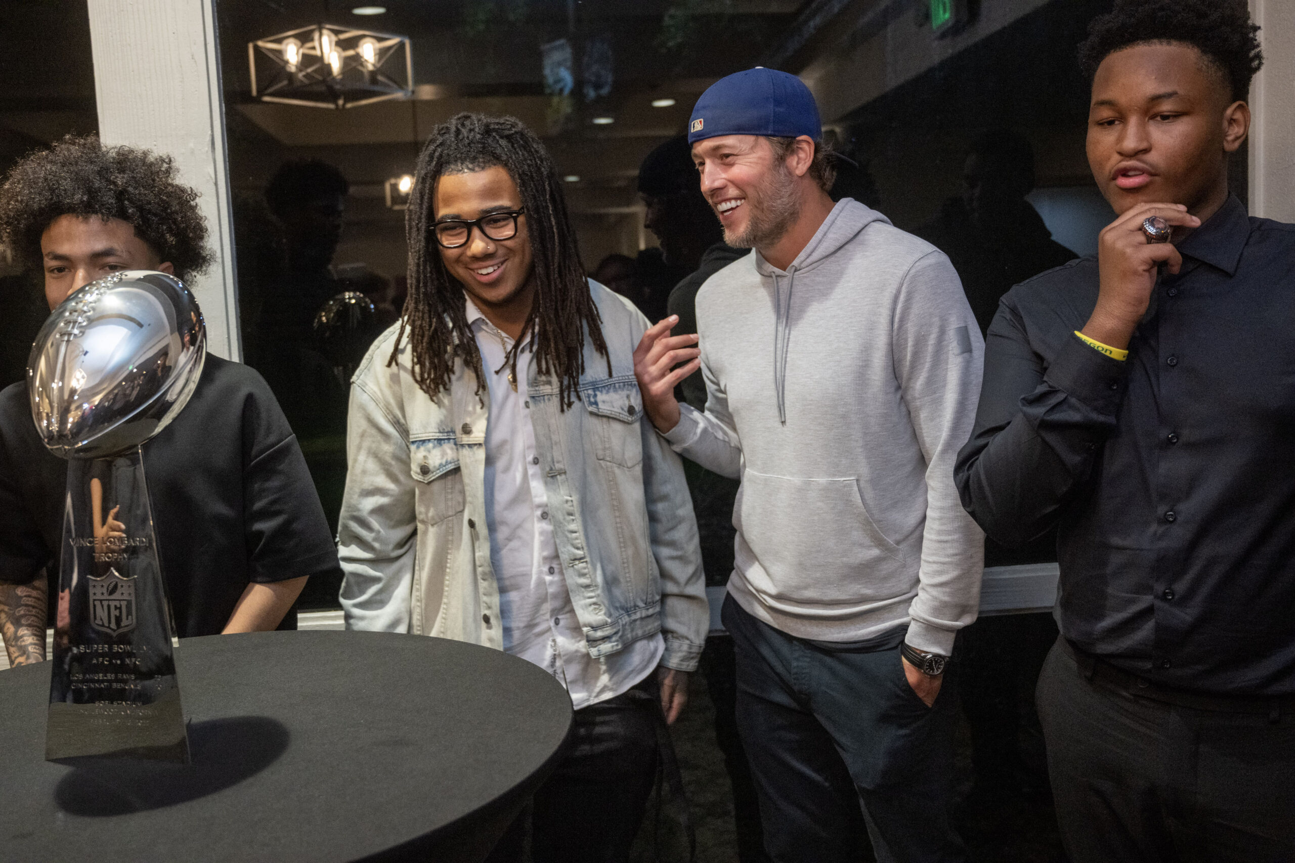 Rams quarterback Matthew Stafford, second from right, poses for photos...