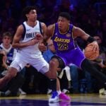 Feb 25, 2025; Los Angeles, California, USA; Los Angeles Lakers forward Rui Hachimura (28) dribbles the ball on Dallas Mavericks guard Max Christie (00) during the first quarter at Crypto.com Arena. Mandatory Credit: Gary A. Vasquez-Imagn Images