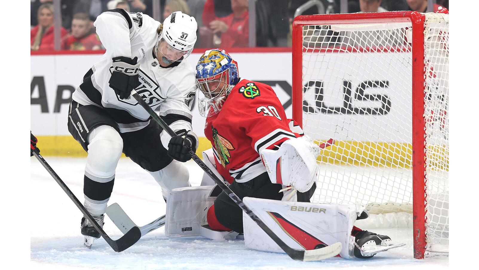 Chicago Blackhawks goaltender Spencer Knight, right, makes a save against...