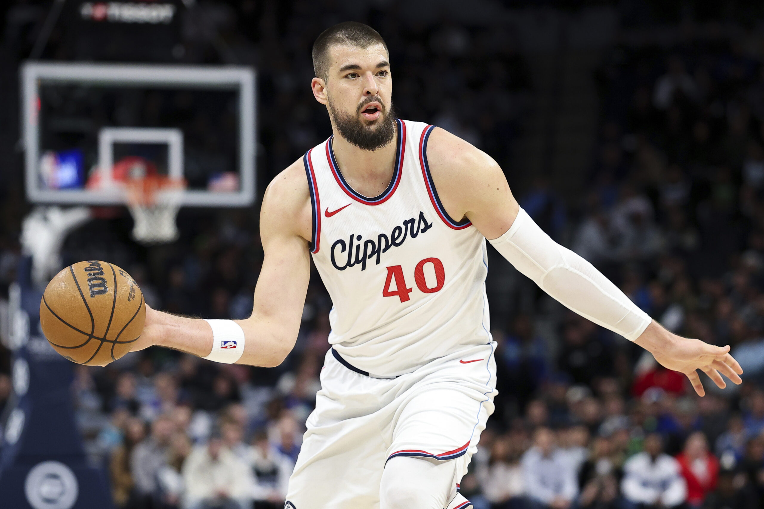 Clippers center Ivica Zubac dribbles the ball during the first...