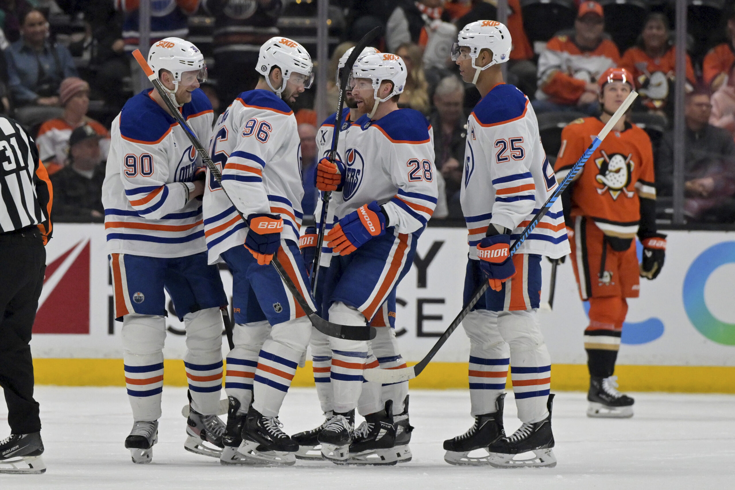 Edmonton Oilers players congratulate defenseman Jake Walman (96) after he...