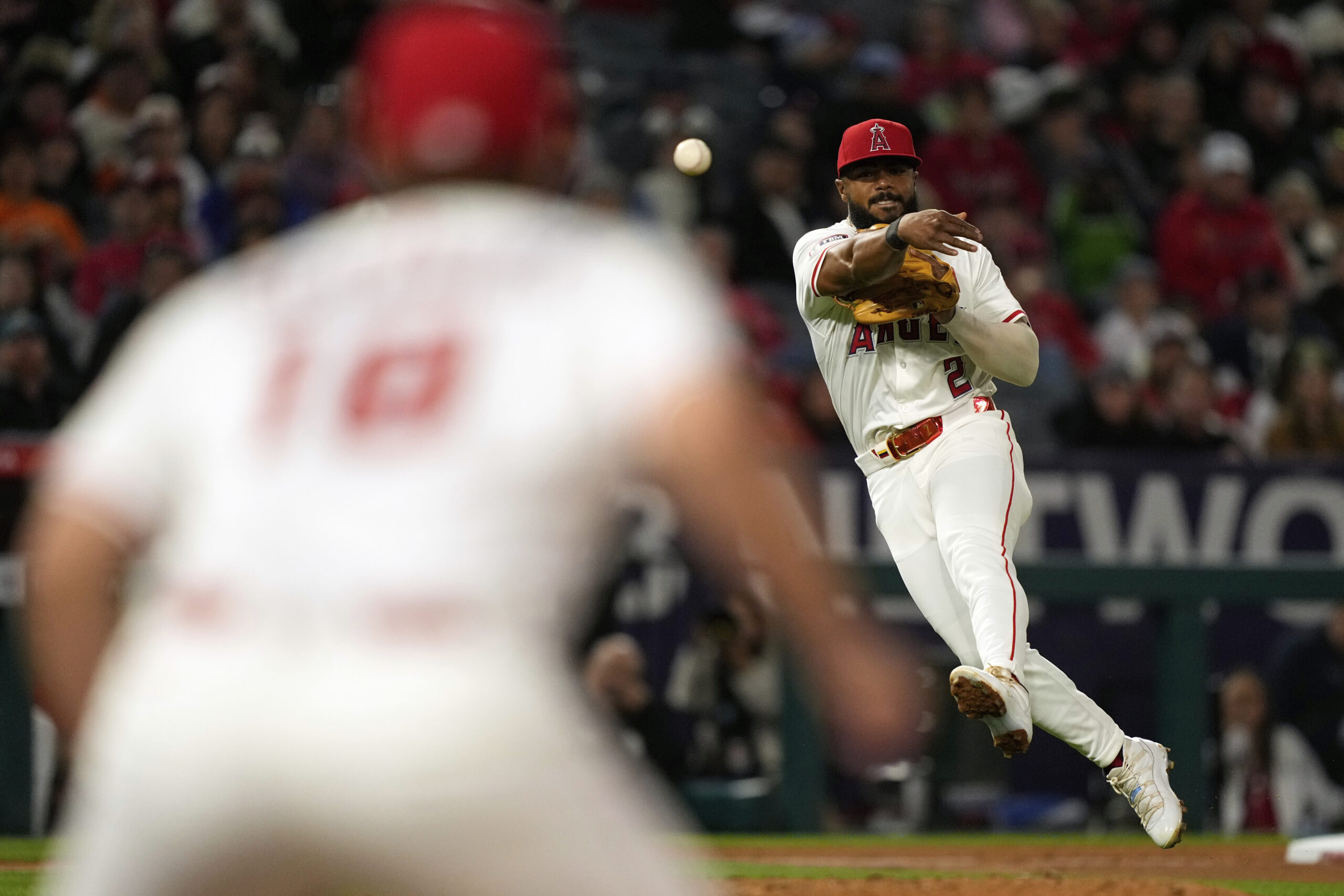 Angels third baseman Luis Rengifo, right, throws out the San...