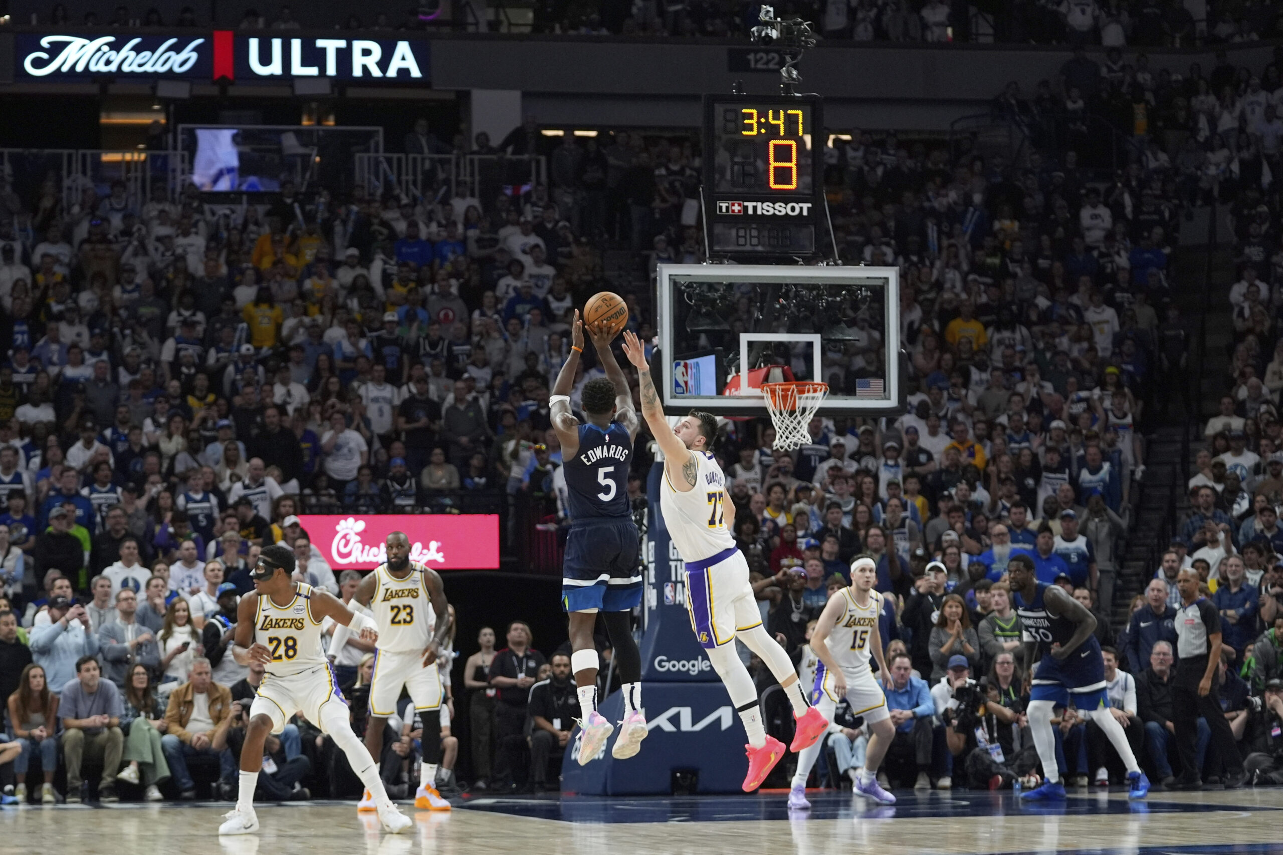 Minnesota Timberwolves guard Anthony Edwards (5) shoots as Lakers guard...