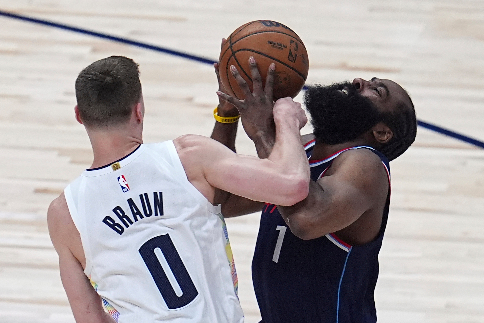 Denver Nuggets guard Christian Braun, left, fouls Clippers guard James...