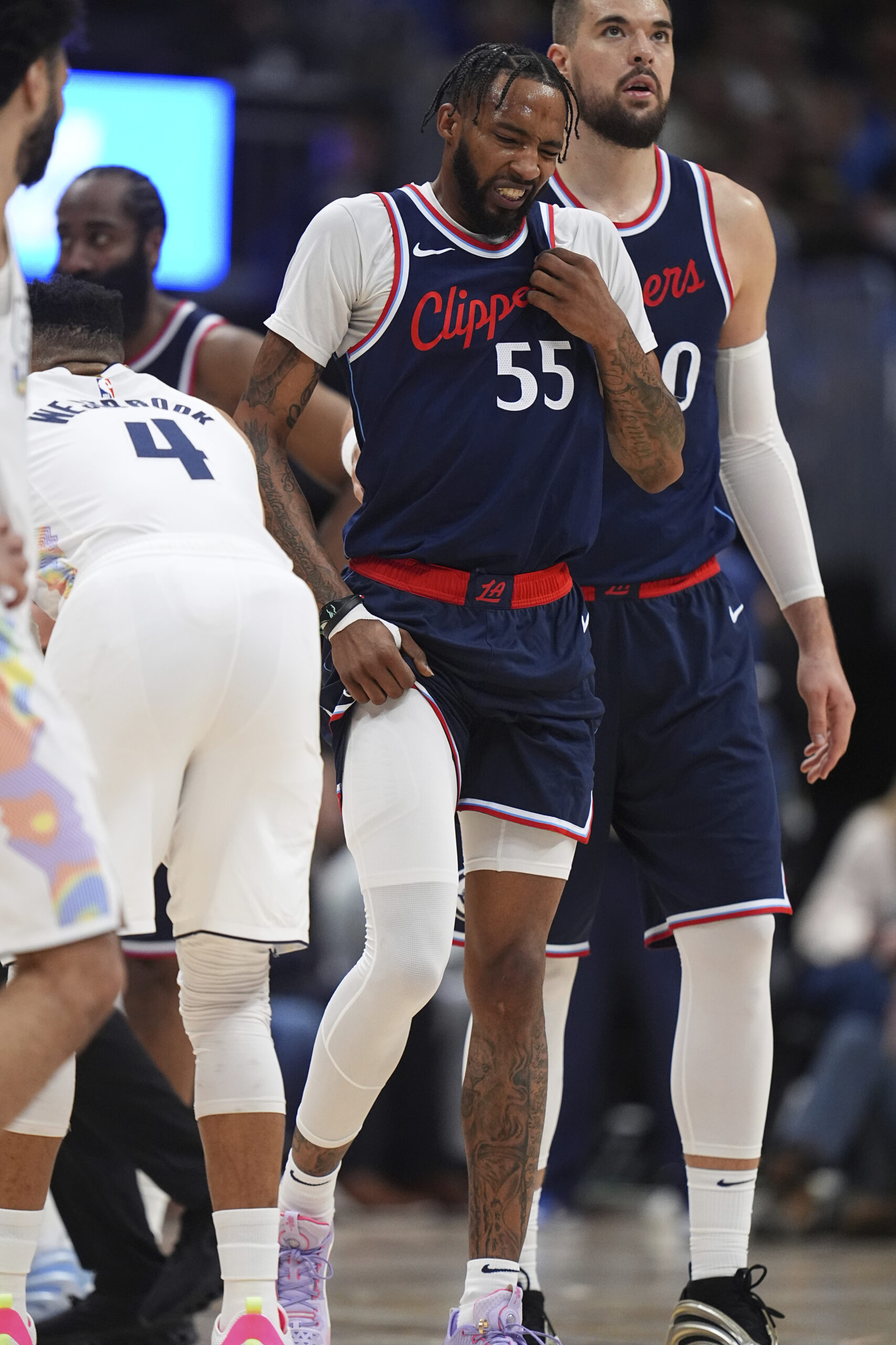 Clippers forward Derrick Jones Jr., center is helped off the...