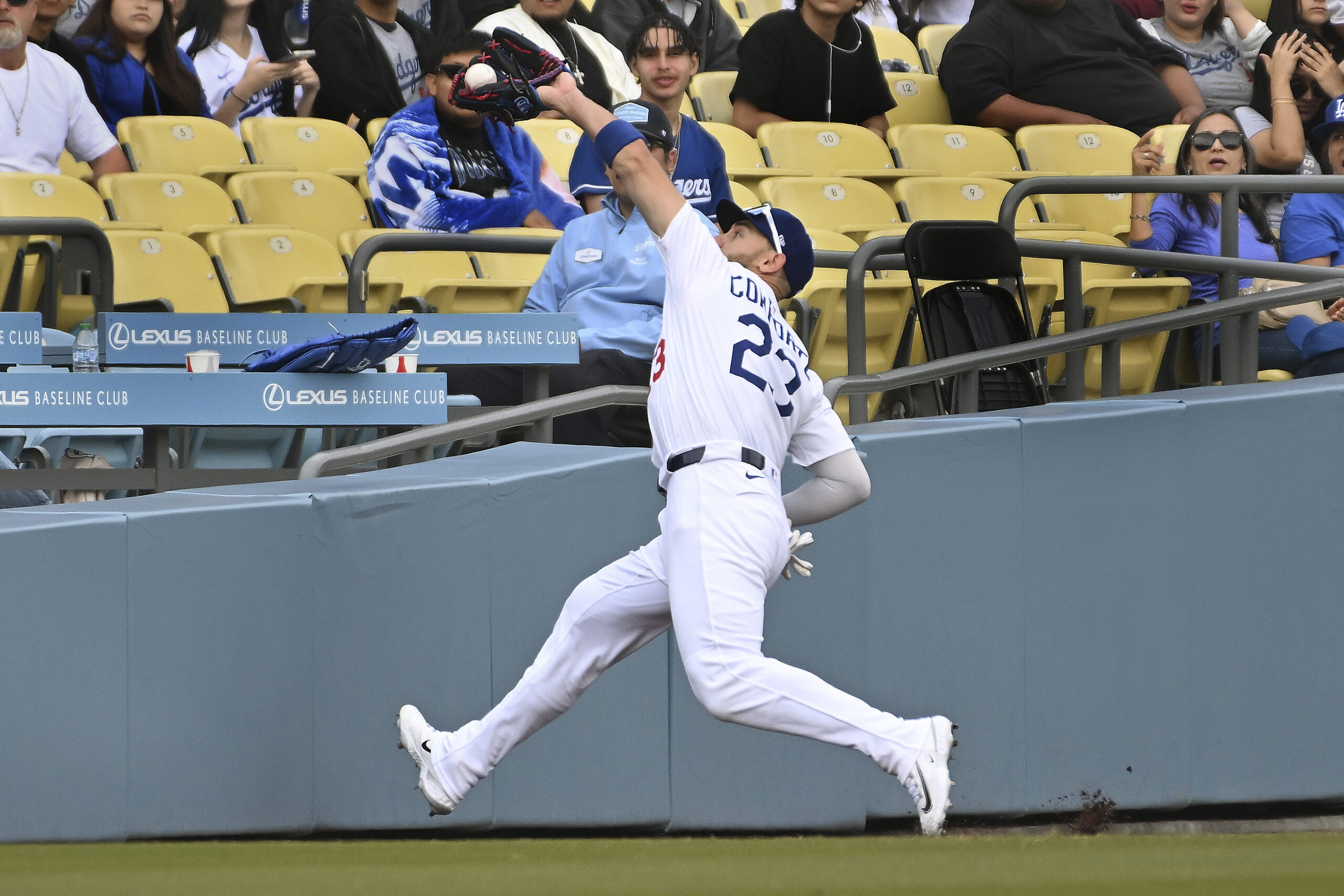 Dodgers left fielder Michael Conforto makes a catch in foul...