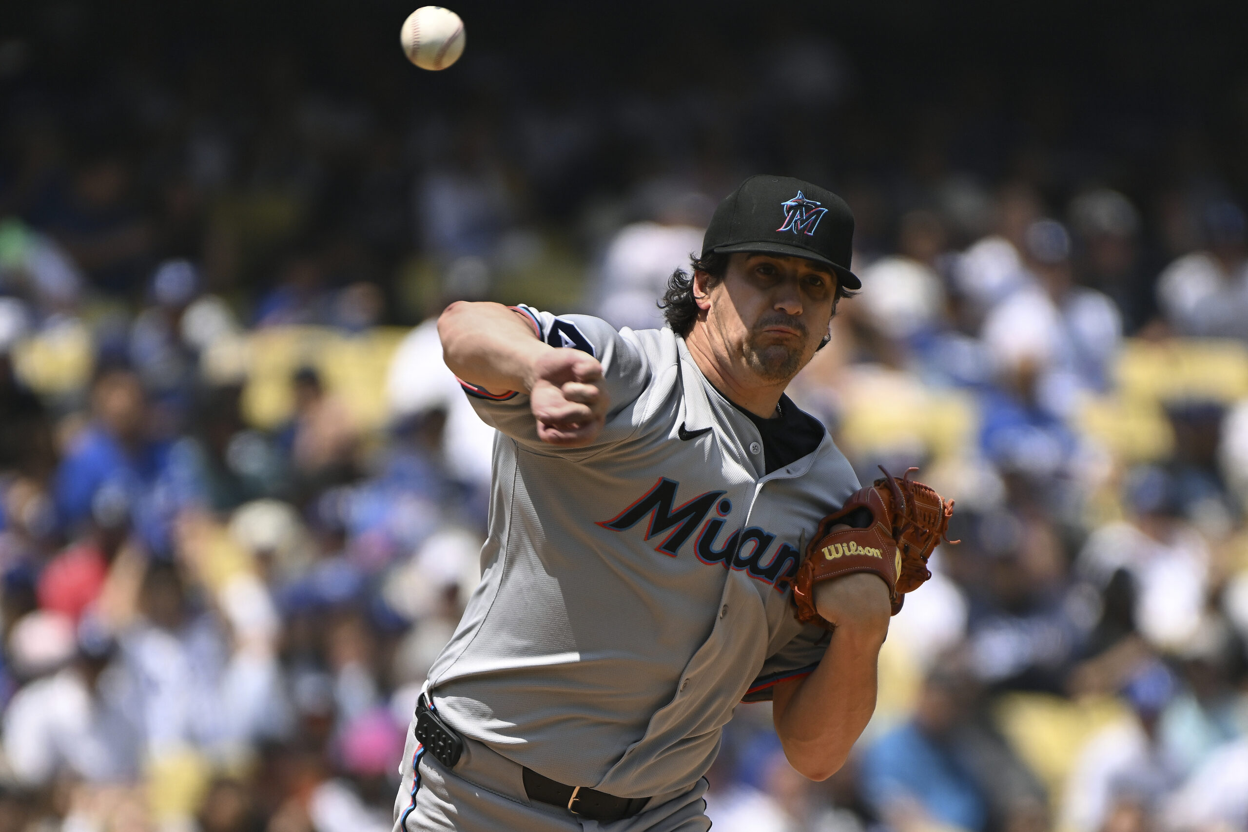 Miami Marlins pitcher Cal Quantrill throws back to first base...