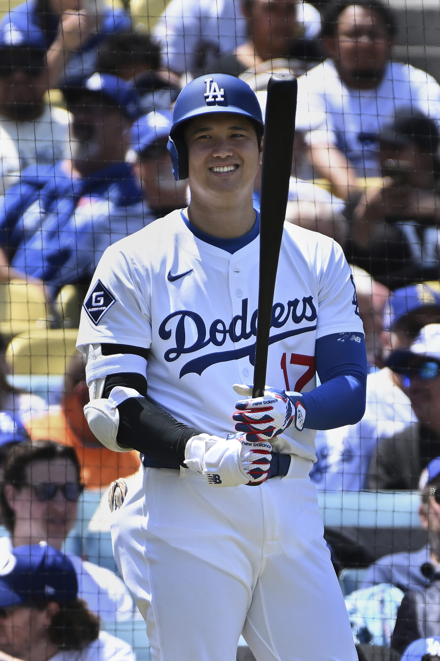 Dodgers star Shohei Ohtani smiles while on deck during a...
