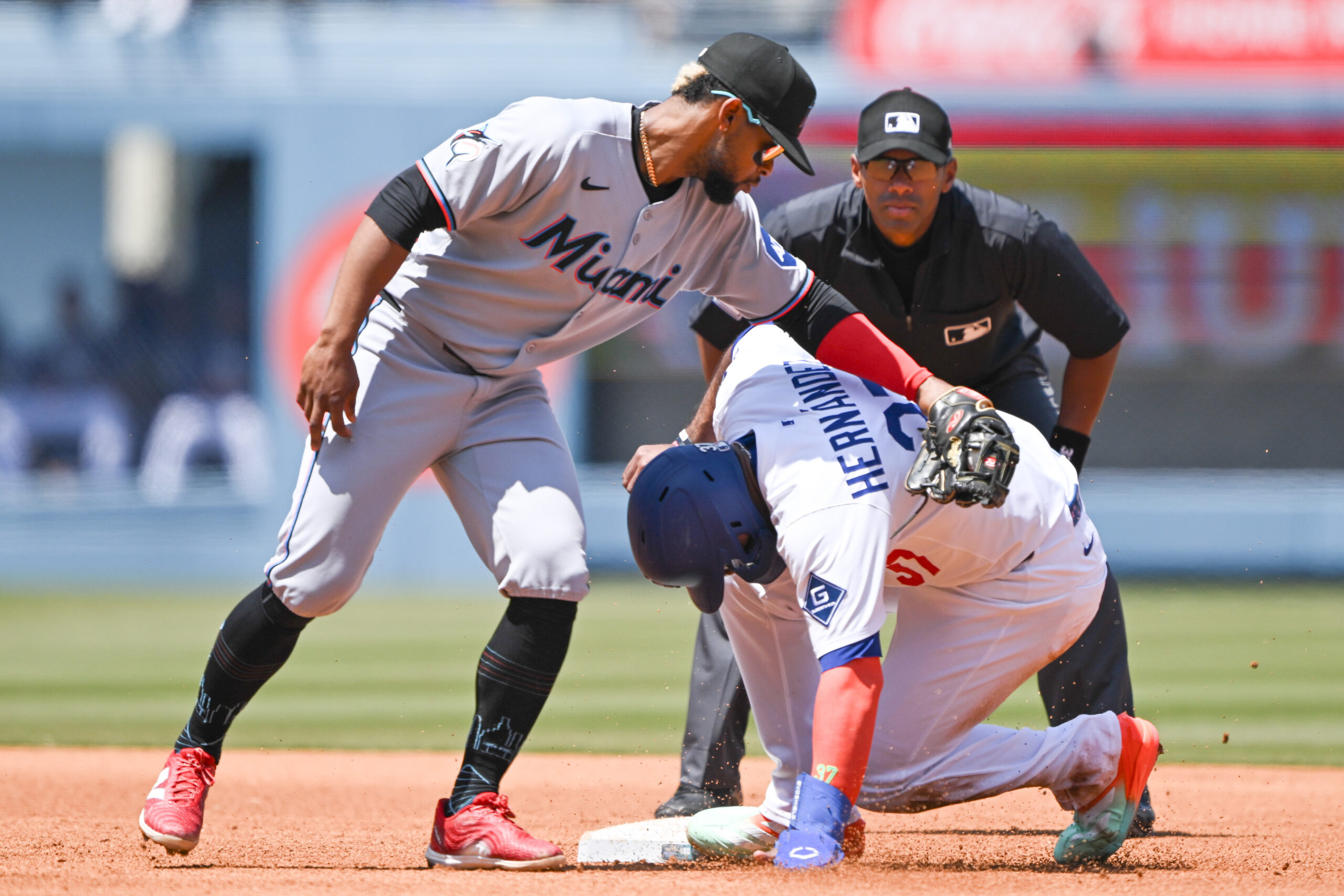The Dodgers’ Teoscar Hernandez is safe at second base as...