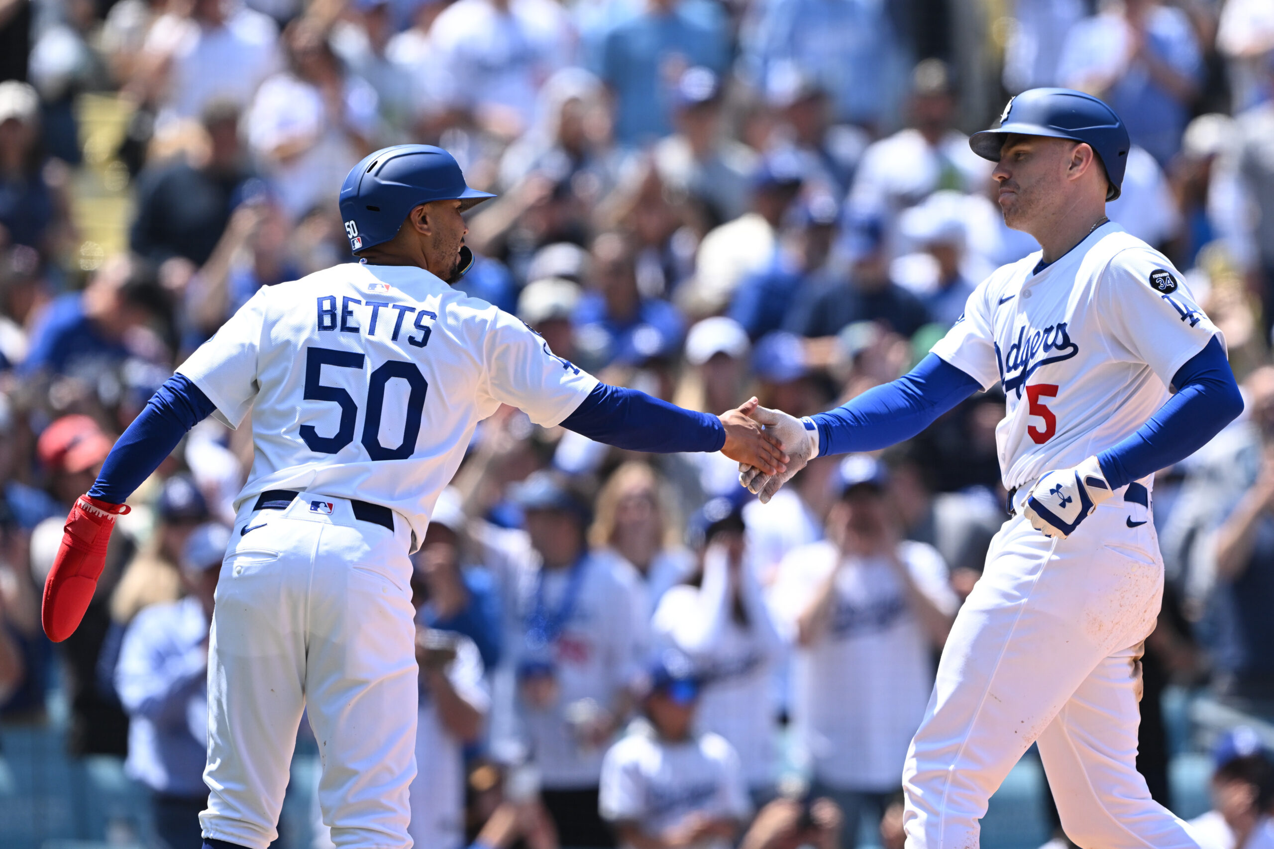 The Dodgers’ Mookie Betts, left, greets teammate Freddie Freeman after...