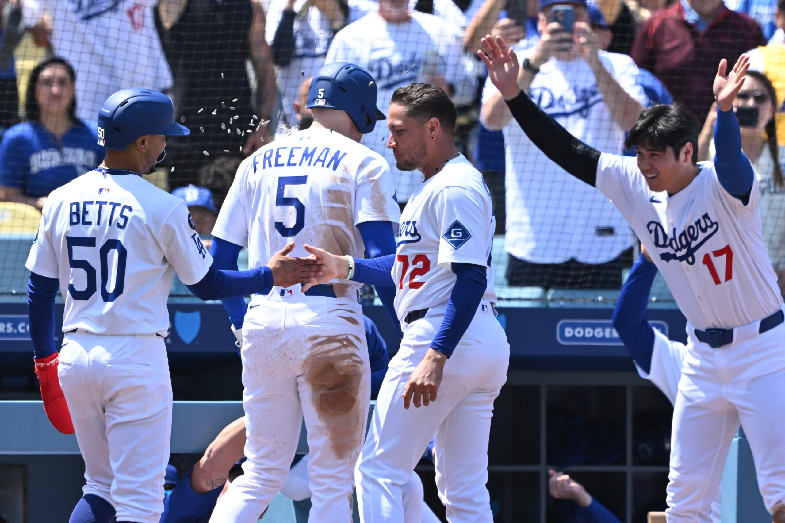 Dodgers star Shohei Ohtani, far right, and infielder Miguel Rojas...