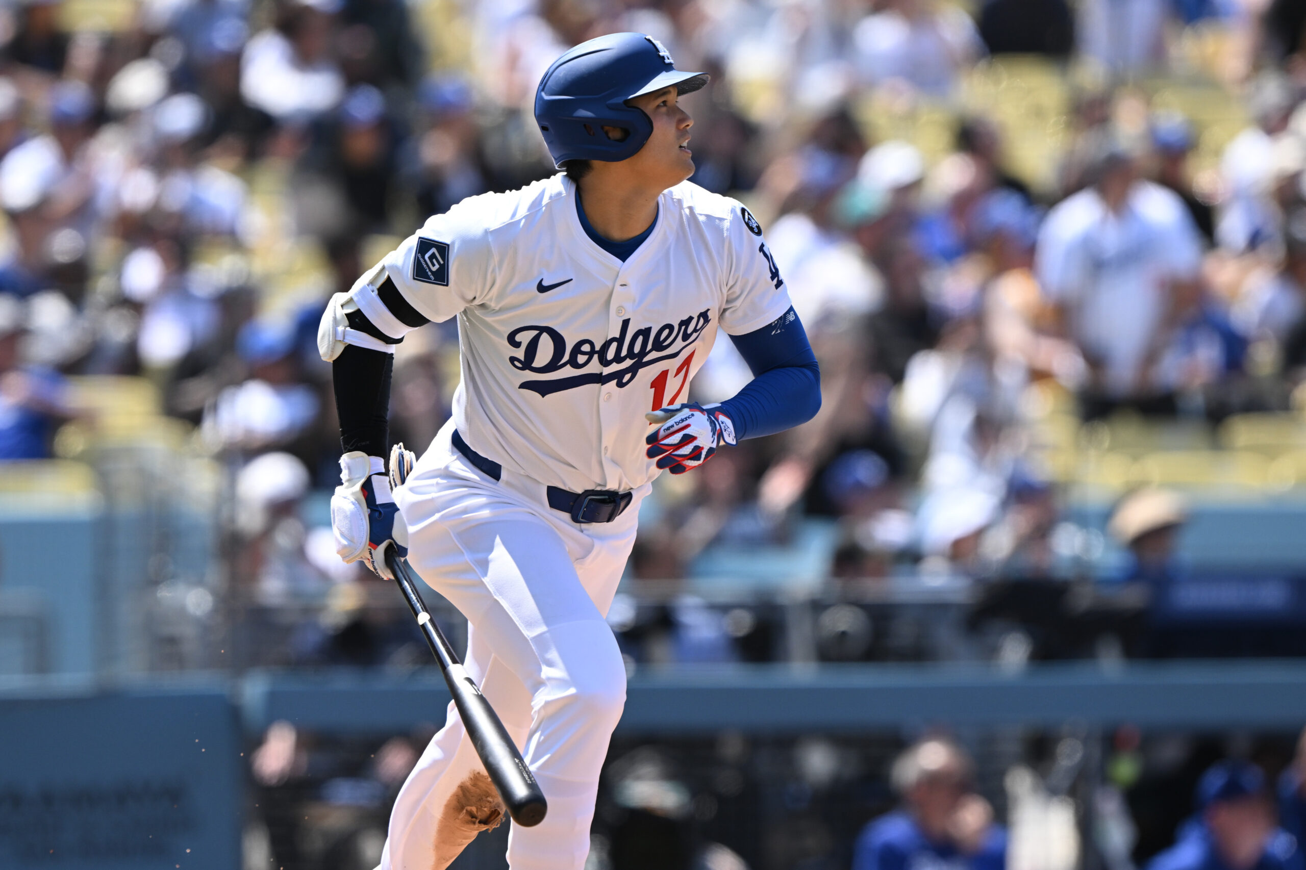 Dodgers star Shohei Ohtani begins to run after hitting a...