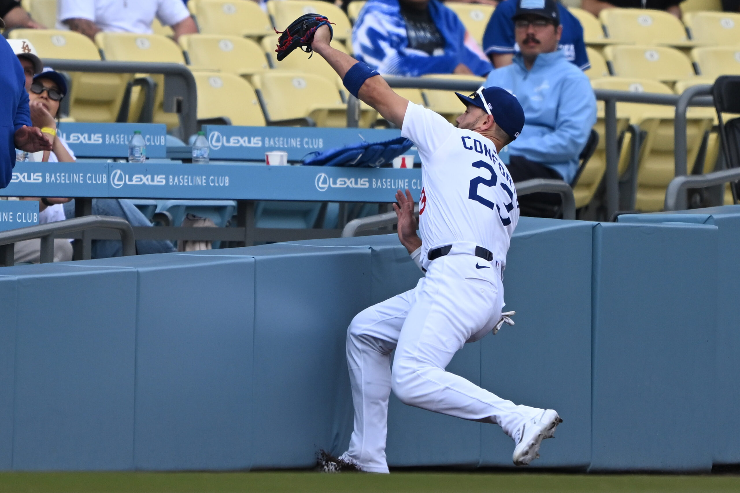 Dodgers left fielder Michael Conforto makes a catch in foul...